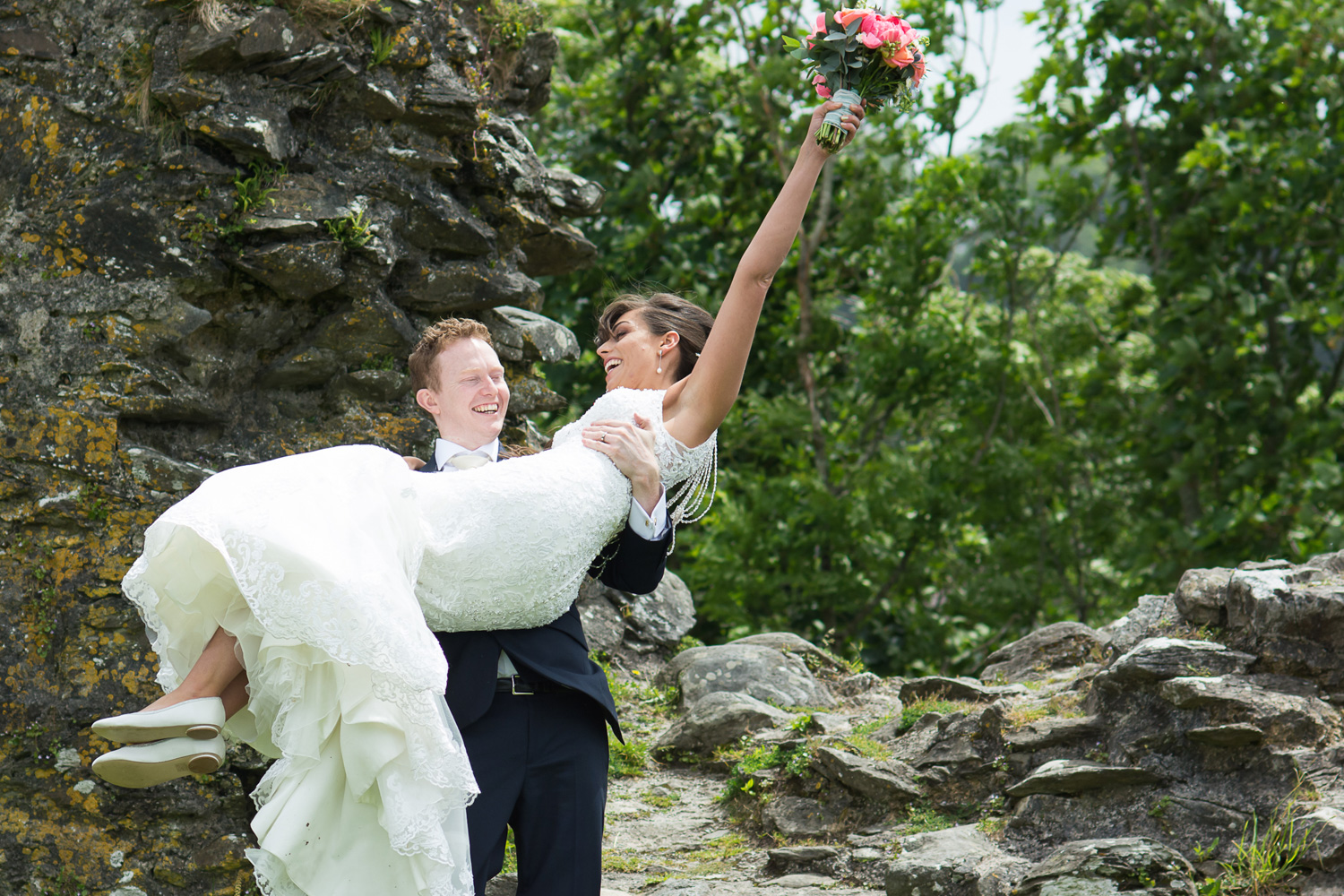 the groom carries the bride during their couple photos with webb family photography