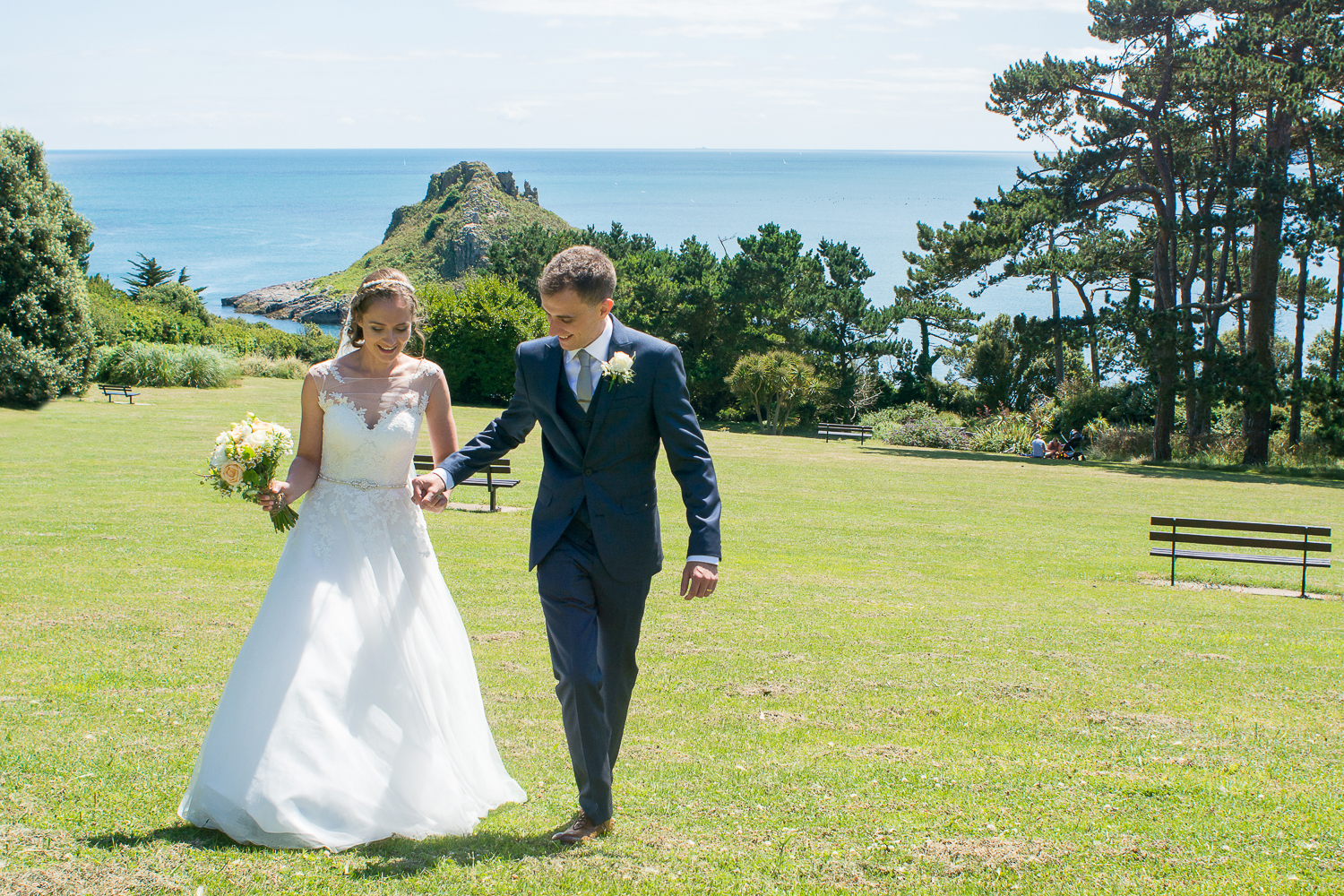 Bride and groom go for a little walk overlooking Thatchers rock in Torquay Devon