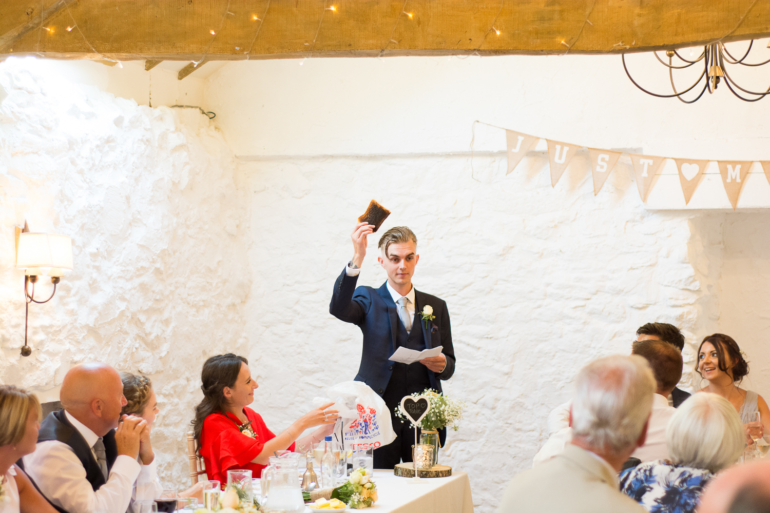 The best man raises a toast (literally) during the speeches at the Bickley Mill in Devon