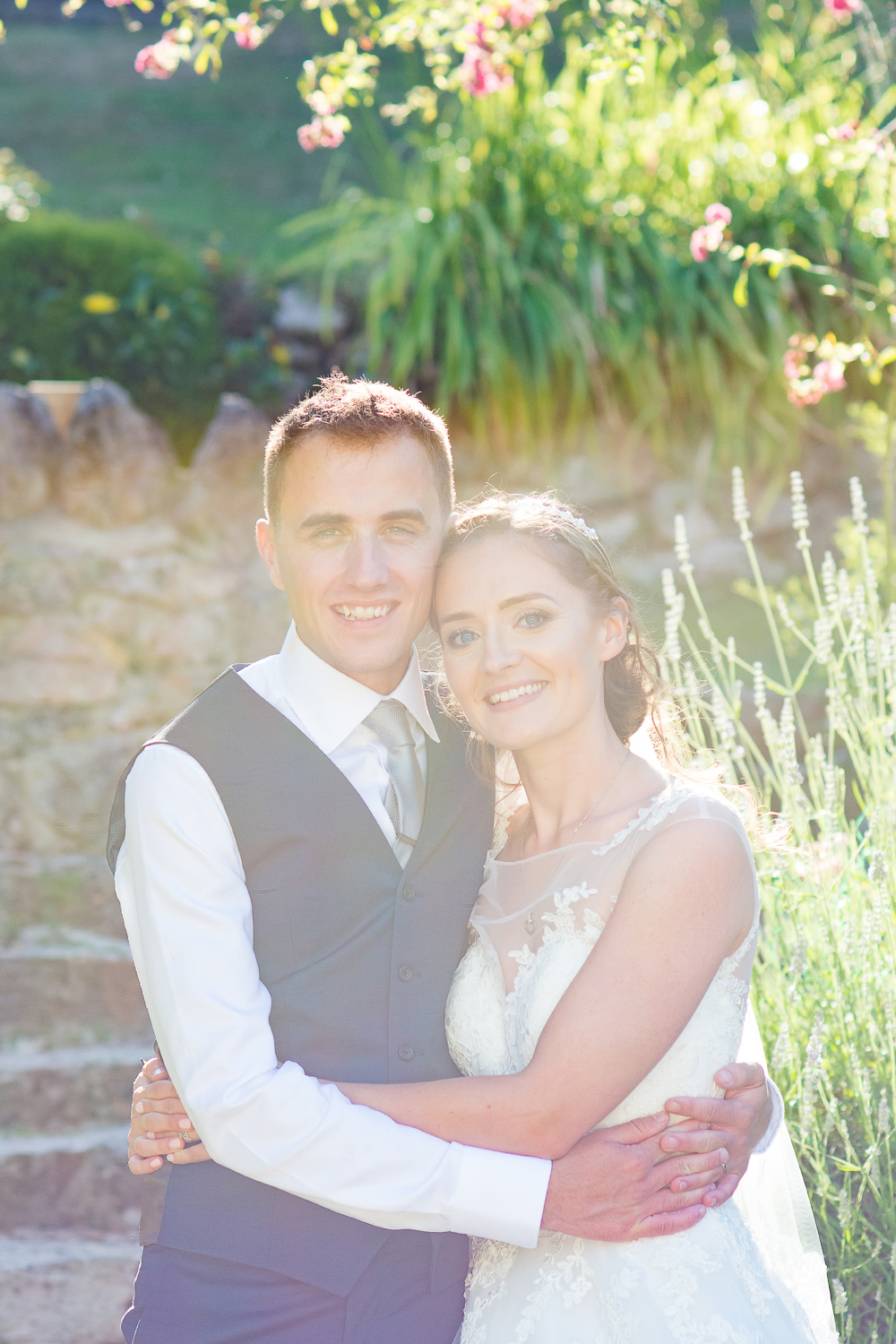 Beautiful Bride and Groom portrait in hazed light in the gardens at the Bickley Mill wedding venue in Devon