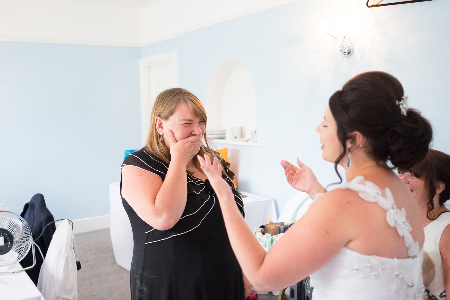 staff member at The Lord Haldon Hotel's reaction to the bride in her dress