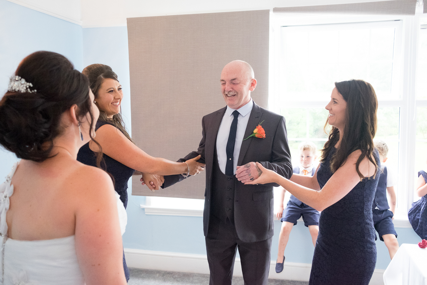 father of the bride closes his eyes ready to see his daughter in her dress at The Lord Haldon Hotel in Devon