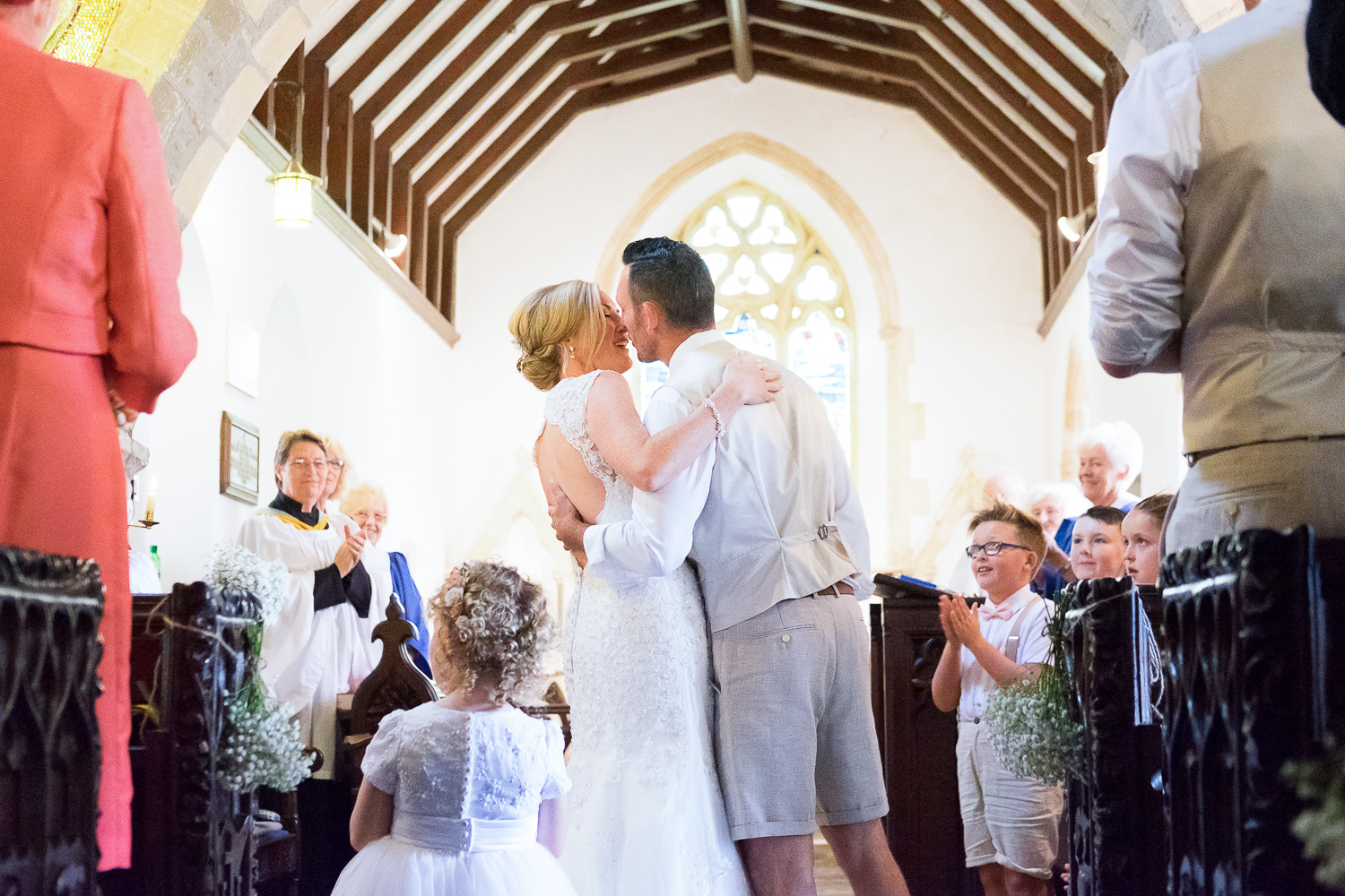 bride and groom first kiss in st mary's church in woolacombe