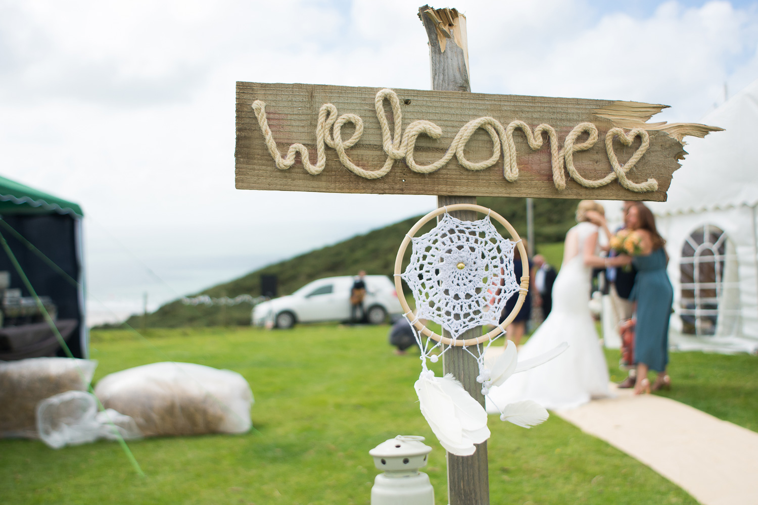 wedding welcome sign and dream catcher at woolacombe festival wedding