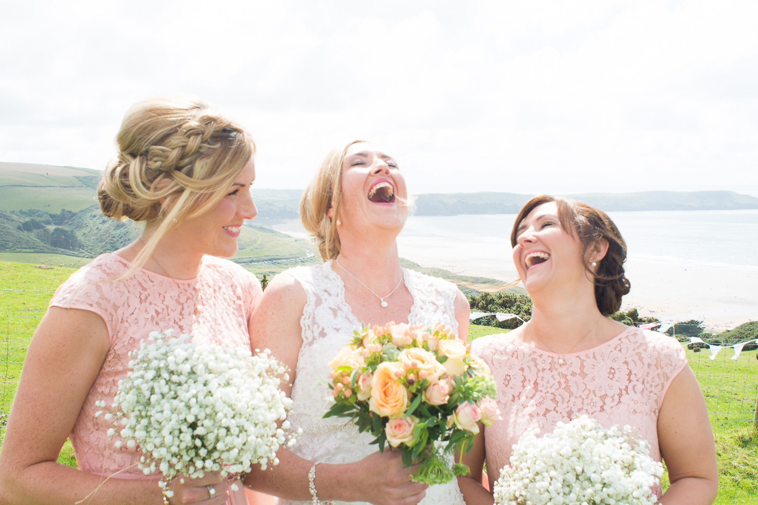 bride and bridesmaids laughing at woolacombe wedding