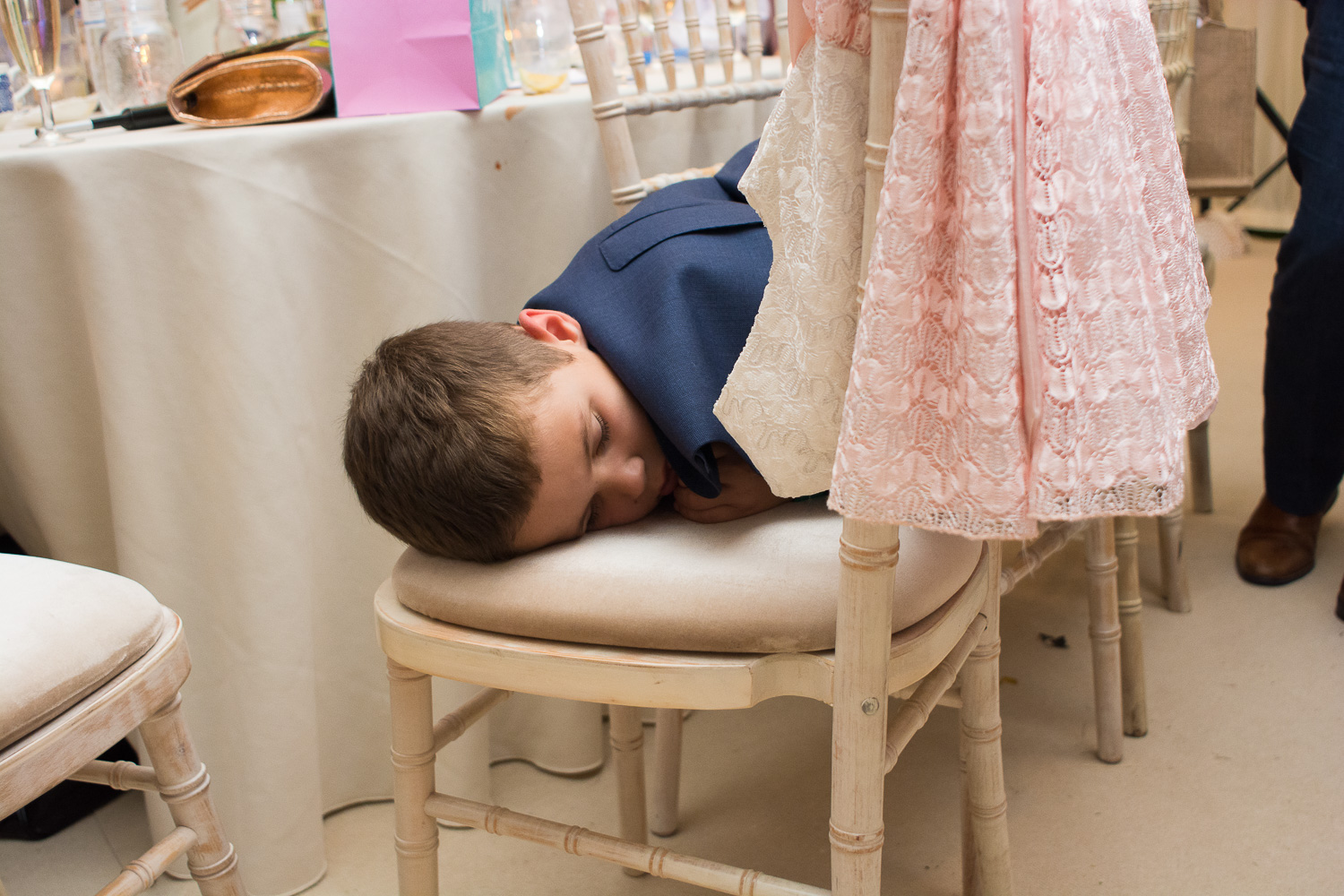 little boy crashed out on chair at woolacombe wedding