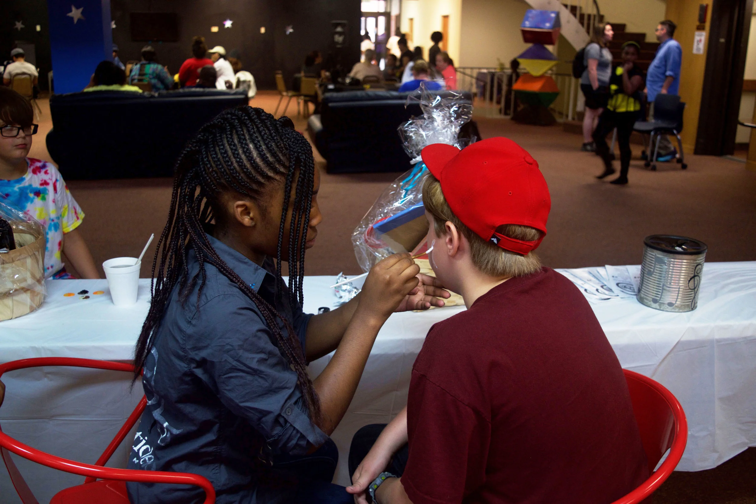 girl-painting-boy's-face-.jpg