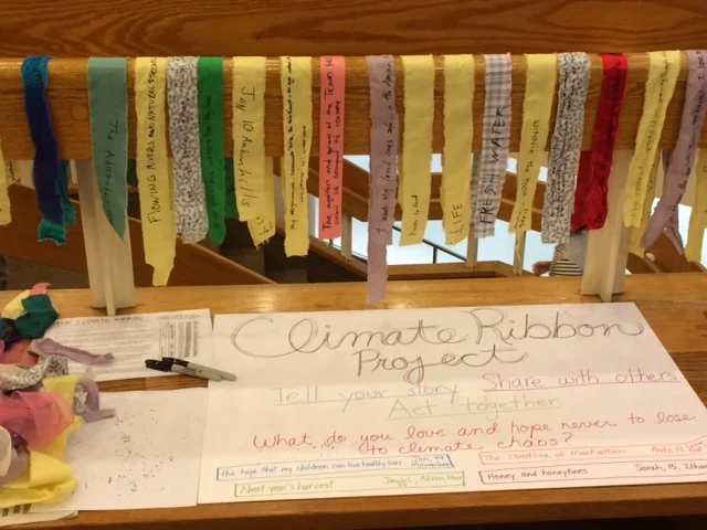Climate ribbon making table at the Opening Plenary session of the Climate Convergence in NYC on Friday, September 19th.
“It was great to be there with so many people who had come to NYC from all over the world. The rail was a perfect place to hang all the ribbons!” ~ Cindi