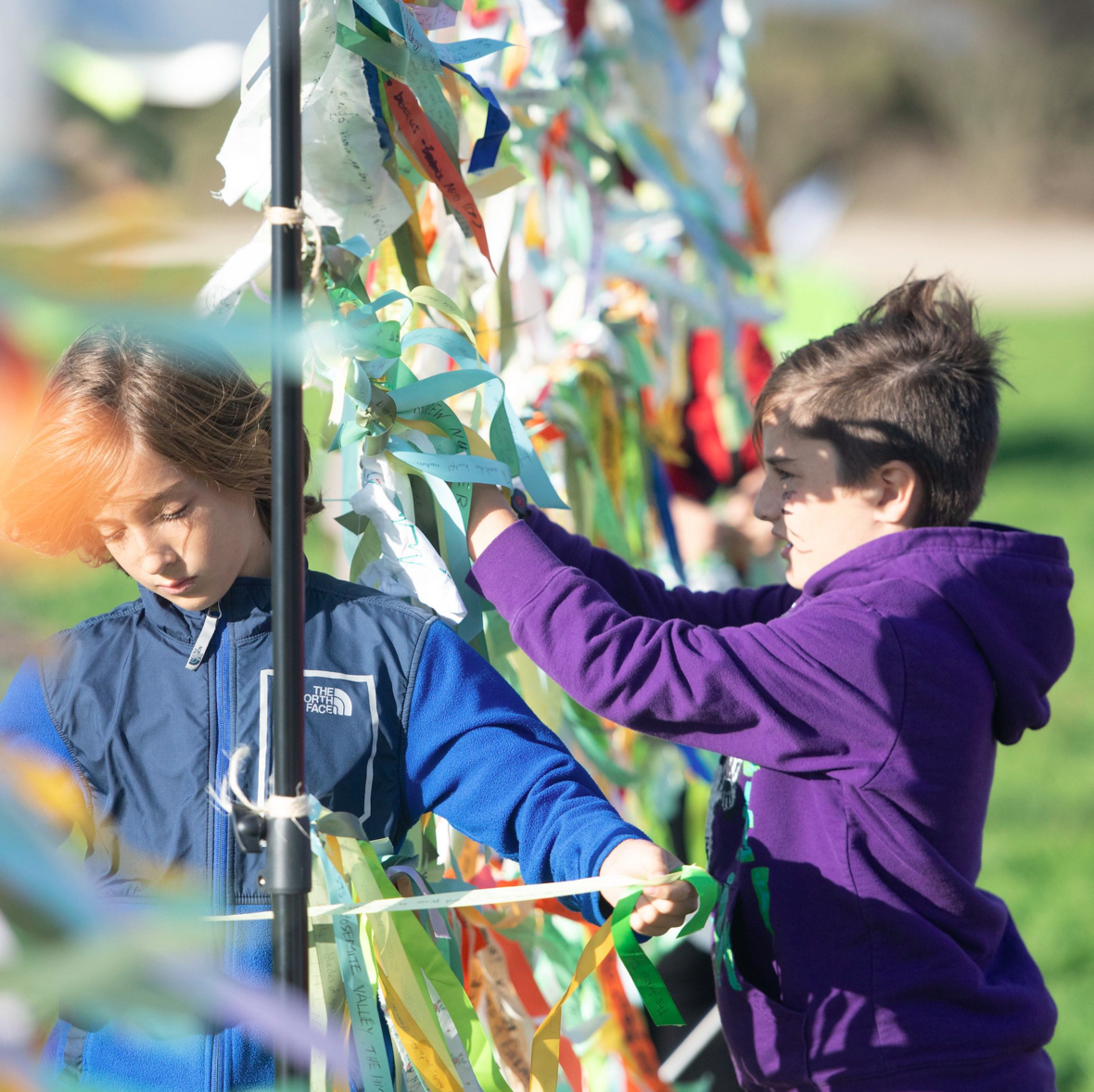 Kids tying ribbons at PCM.9-18.png