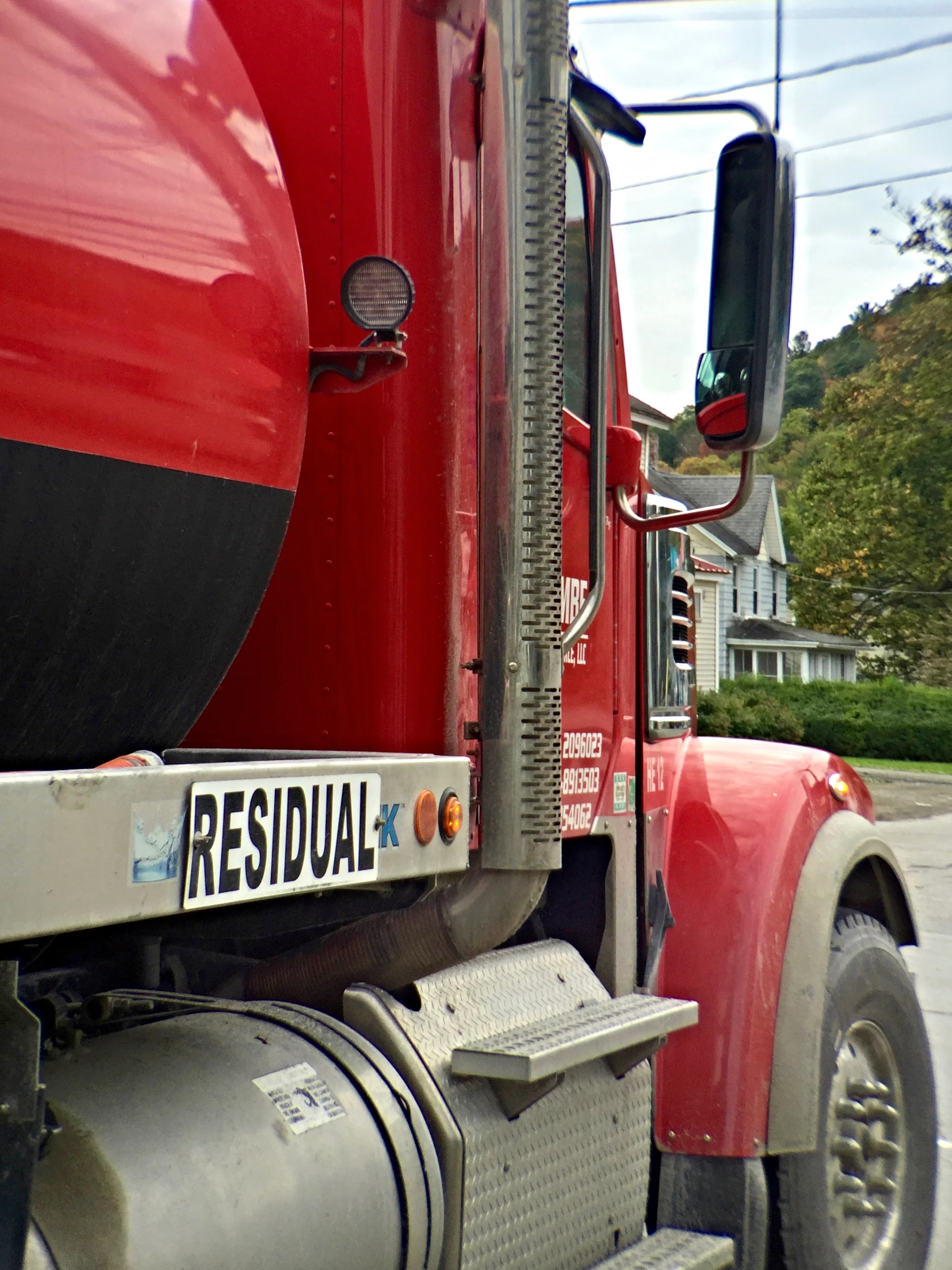 A wastewater truck pulls up beside me at an intersection.