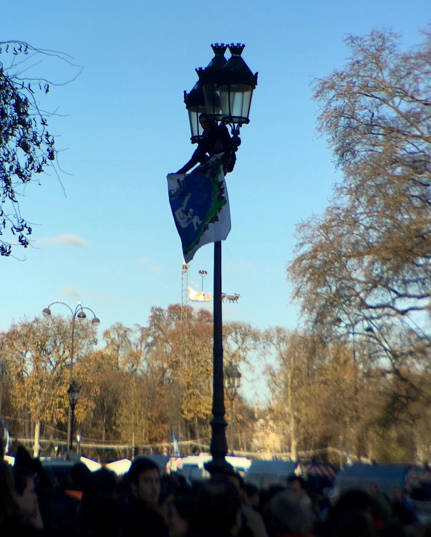 Outside the exhibit activists gathered to support a lightpole climber shouting anti-corporate slogans.