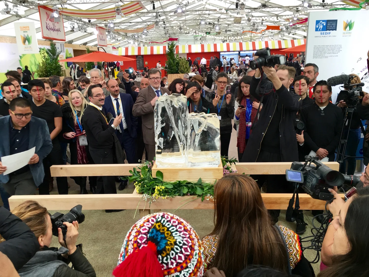 Inside the "Green Zone", a space for public events adjacent to the Delegate Hall, occasional protests would spring up. This was a mock funeral for Ecuadoreans. Ice and pallbearers.&nbsp;