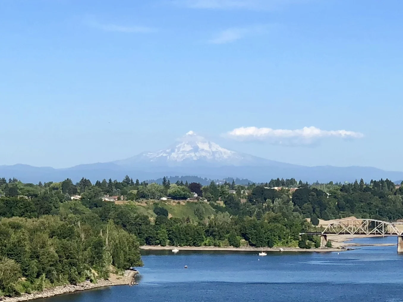 Mt. Hood looms in the distance off the Saint John's bridge across the Willamette River. 
