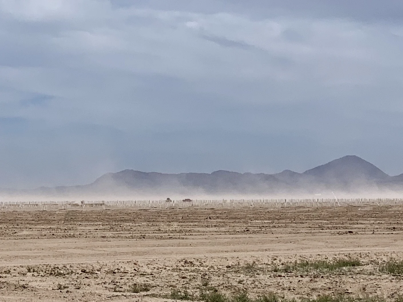 The wind stirs up dust on the way to Lordsburg.