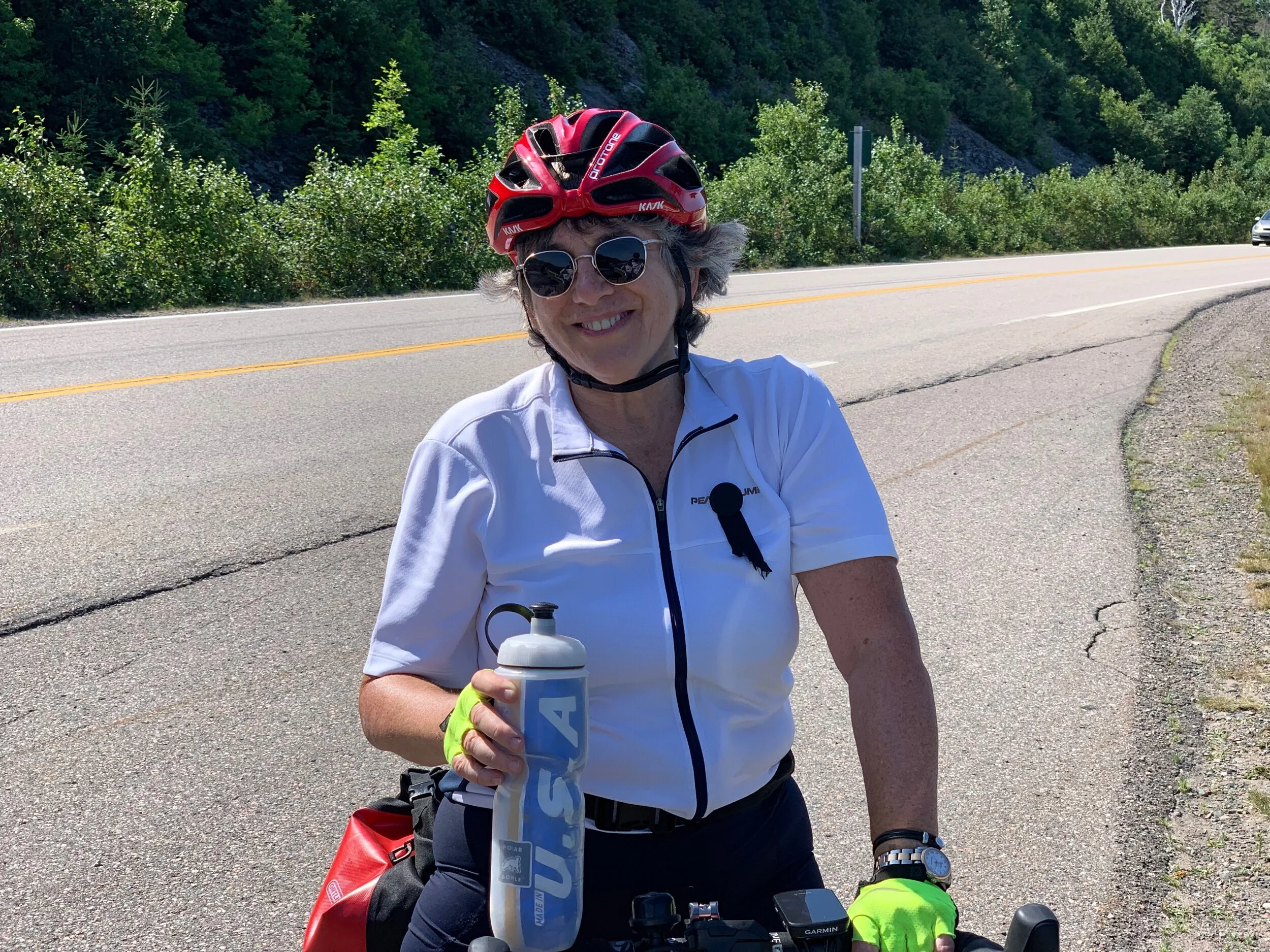 Jenny by the roadside in PEI. She is wearing a mourners ribbon signifying the period of shiva after the death of her mother Merle Weisman.