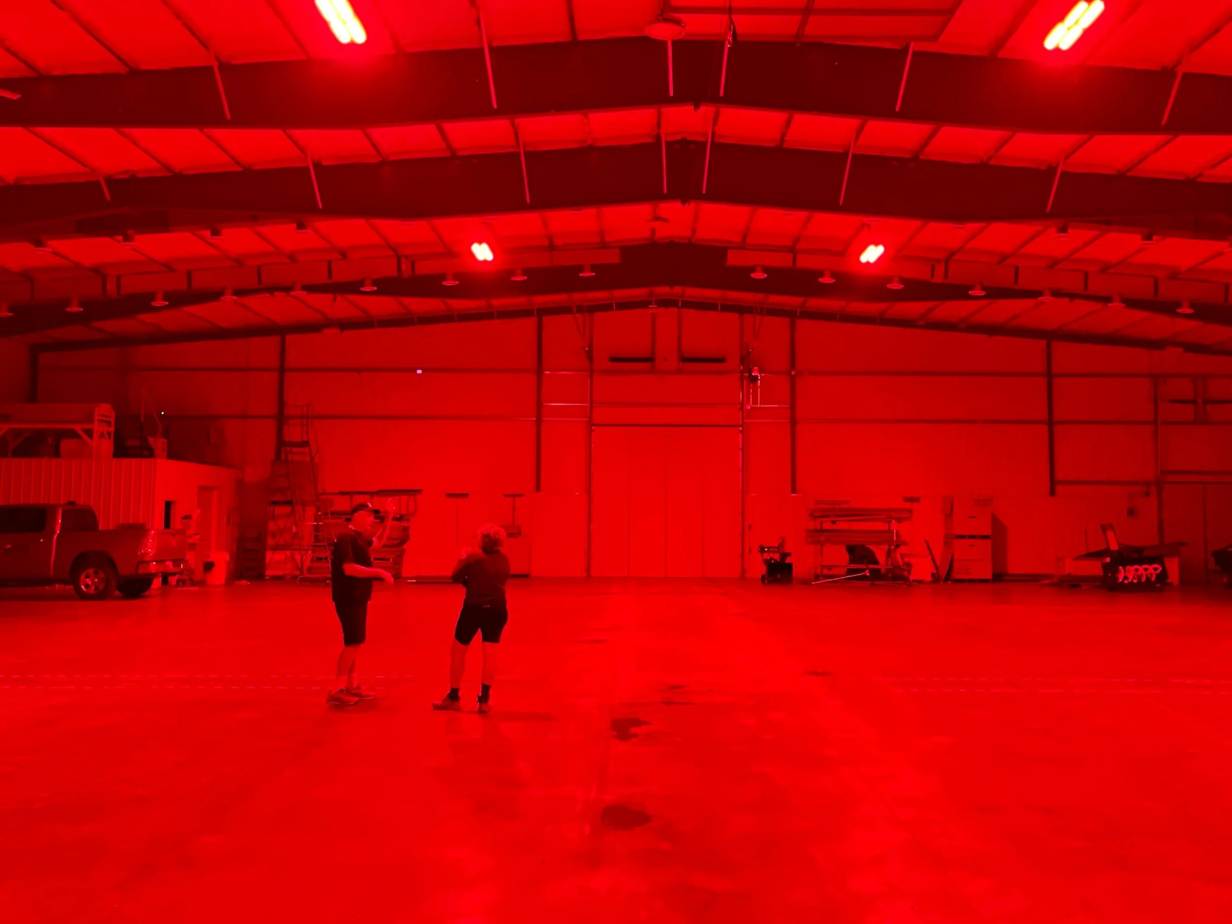 John Miller and Jenny Hershey in the Miller Honey winter bee  storage facility in Gecko, ND. The light is infrared and won’t disturb resting bees. Photo by Michael Chase.