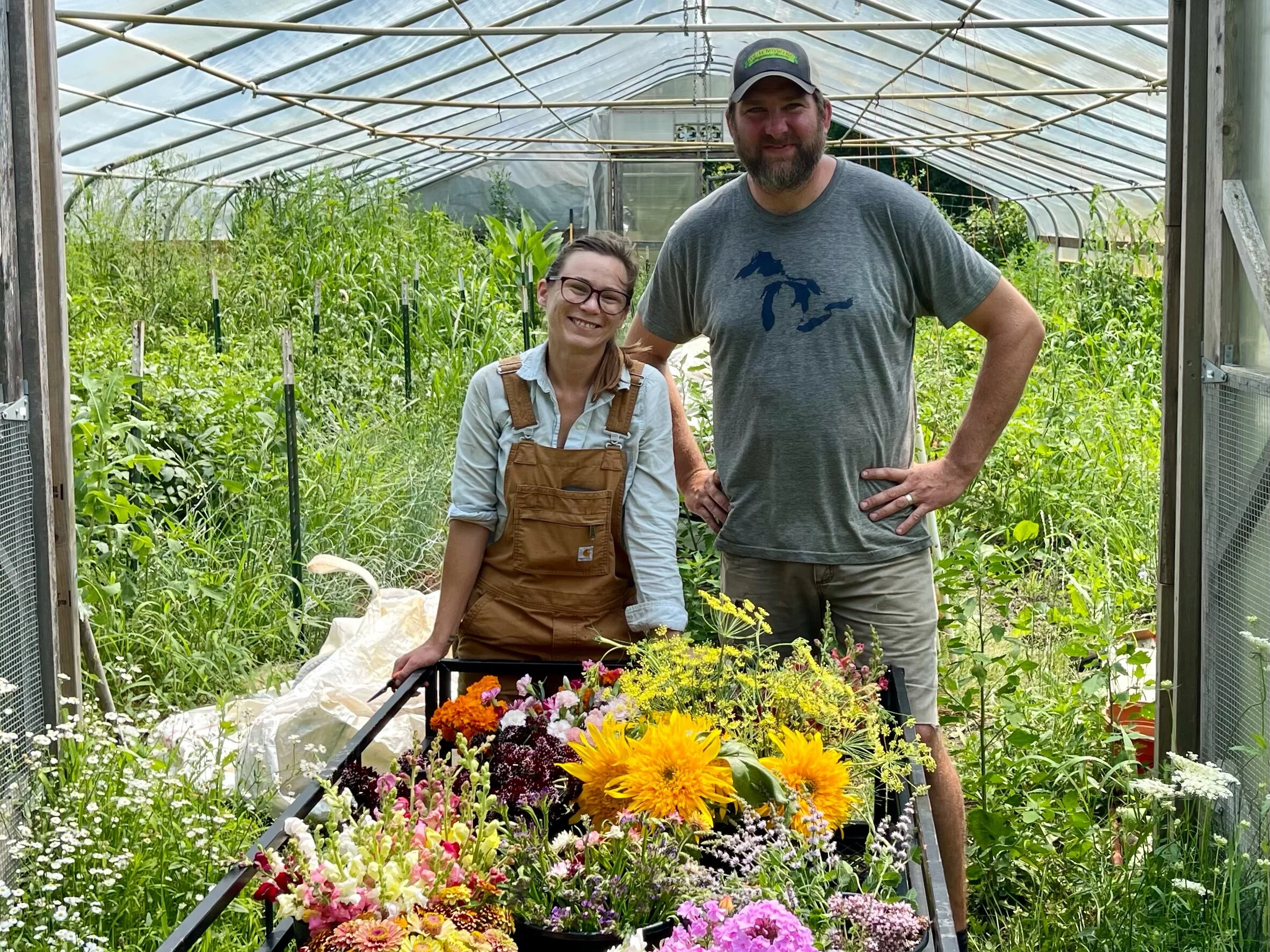 Heather, the Garden Manager at Verdant Hollow Farms stands in front of a very productive hoop house with Brett. When we met her, Heather was filling this wagon with flowers to deliver to local community supported agriculture (CSA ) customers.