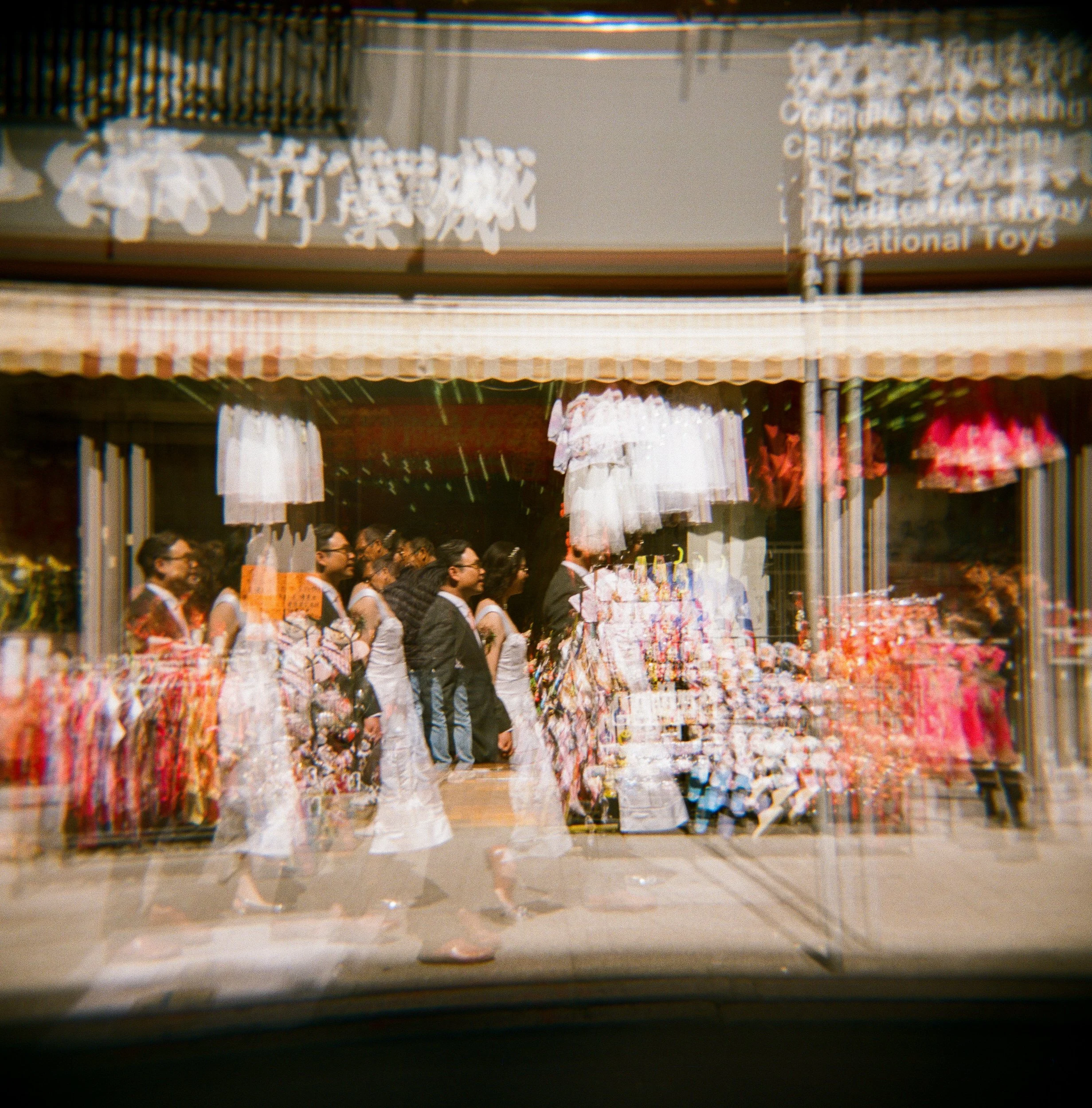 A multiple exposure photo of a couple walking through Chinatown.