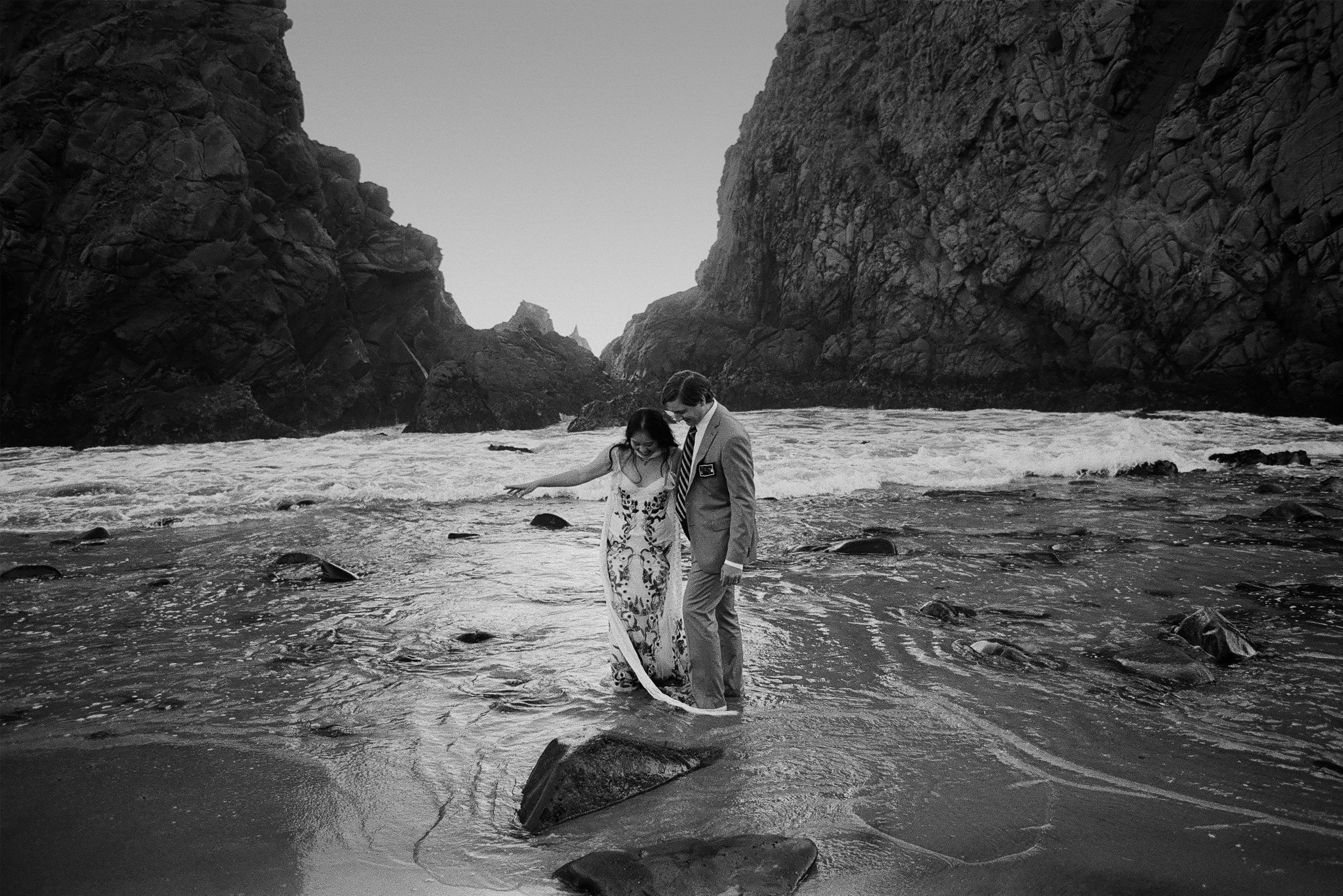Big Sur elopement shot on 35mm film with a couple in the waves at Pfeiffer Beach.