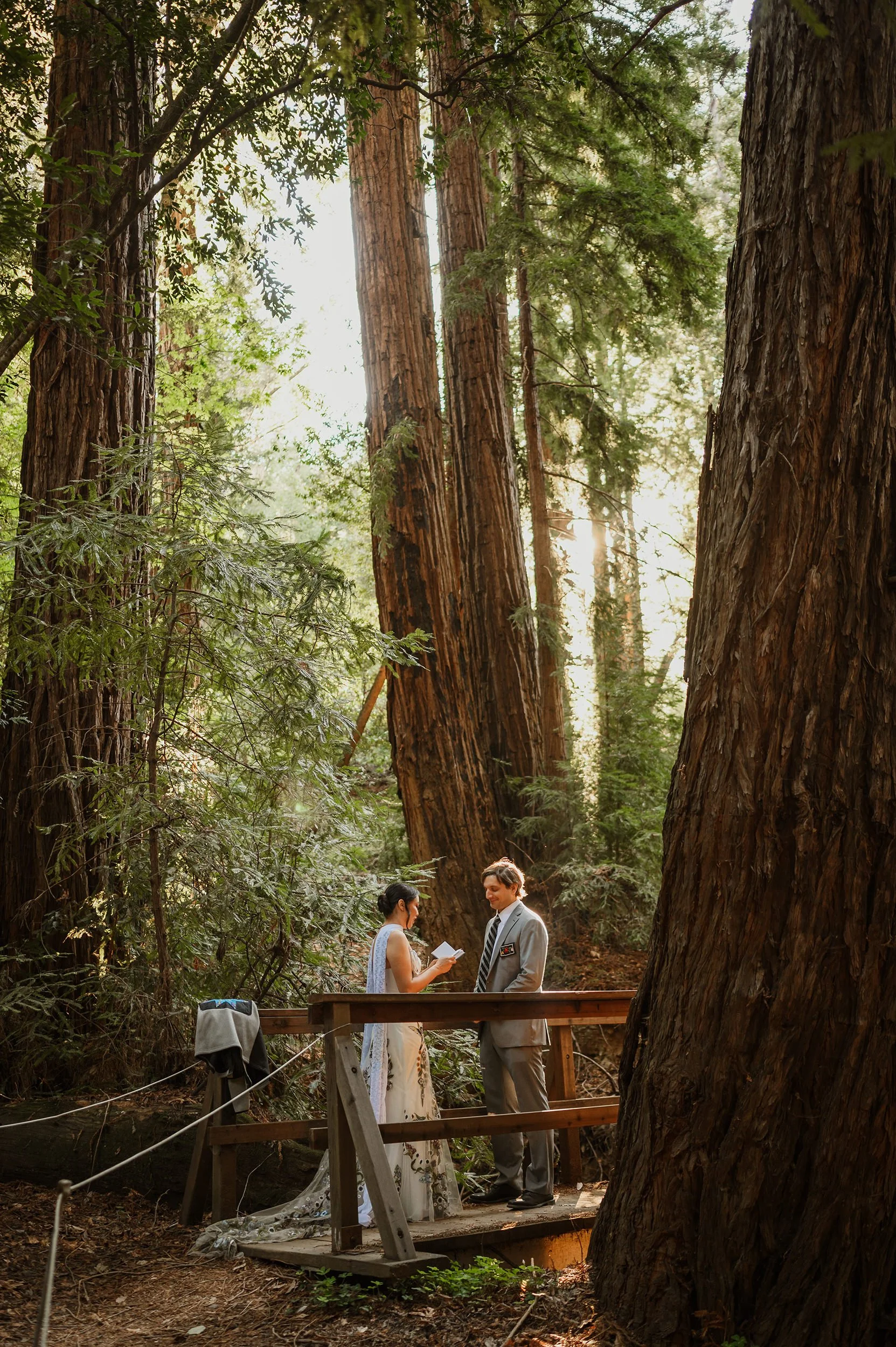 A couple in the redwoods in Big Sur exchanging vows for their elopement.