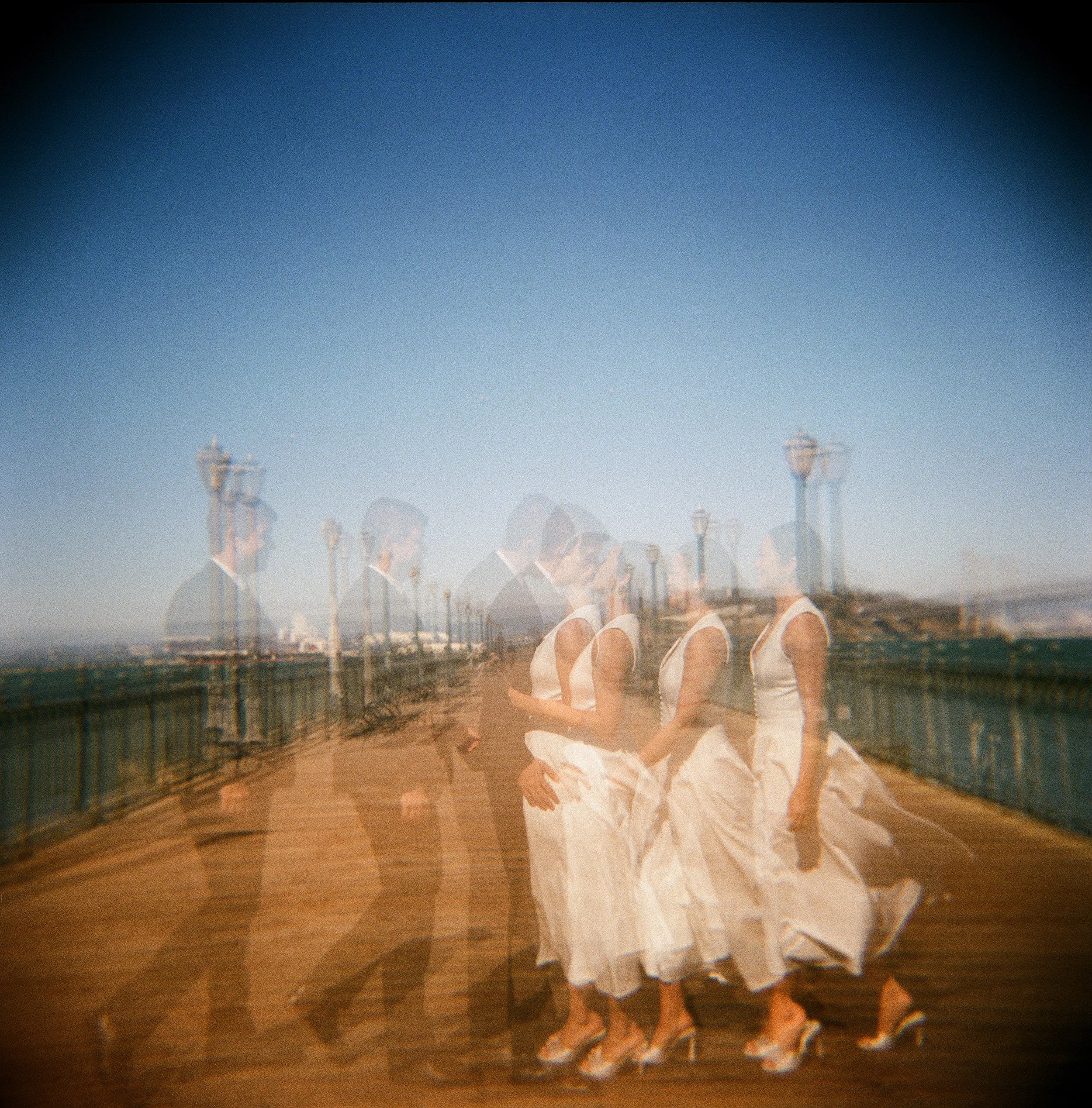 A multiple exposure photo of an elopement couple kissing on Pier 7 in San Francisco shot on Holga with Kodak Portra 400