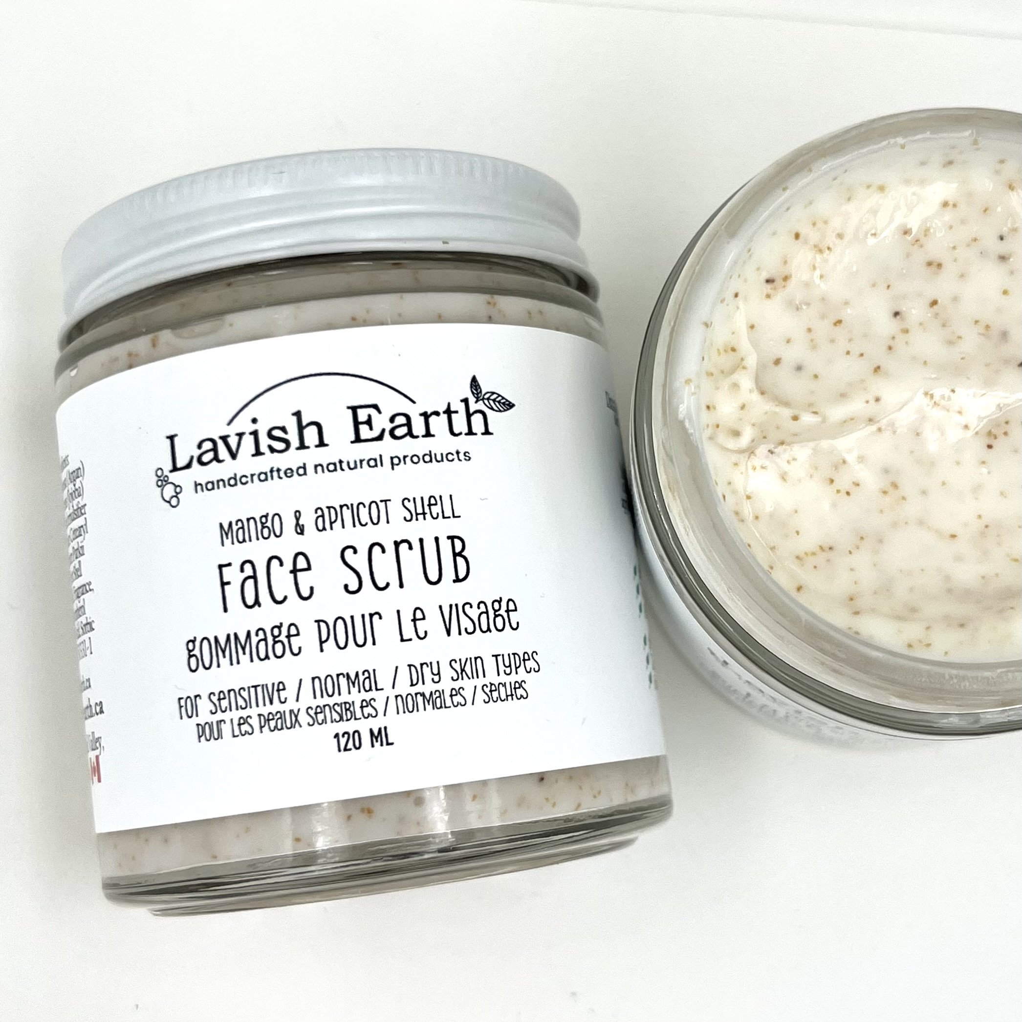 Lavish Earth Apricot Shell exfoliant in creamy lotion texture shown packaged in glass jar with metal lid Ontario