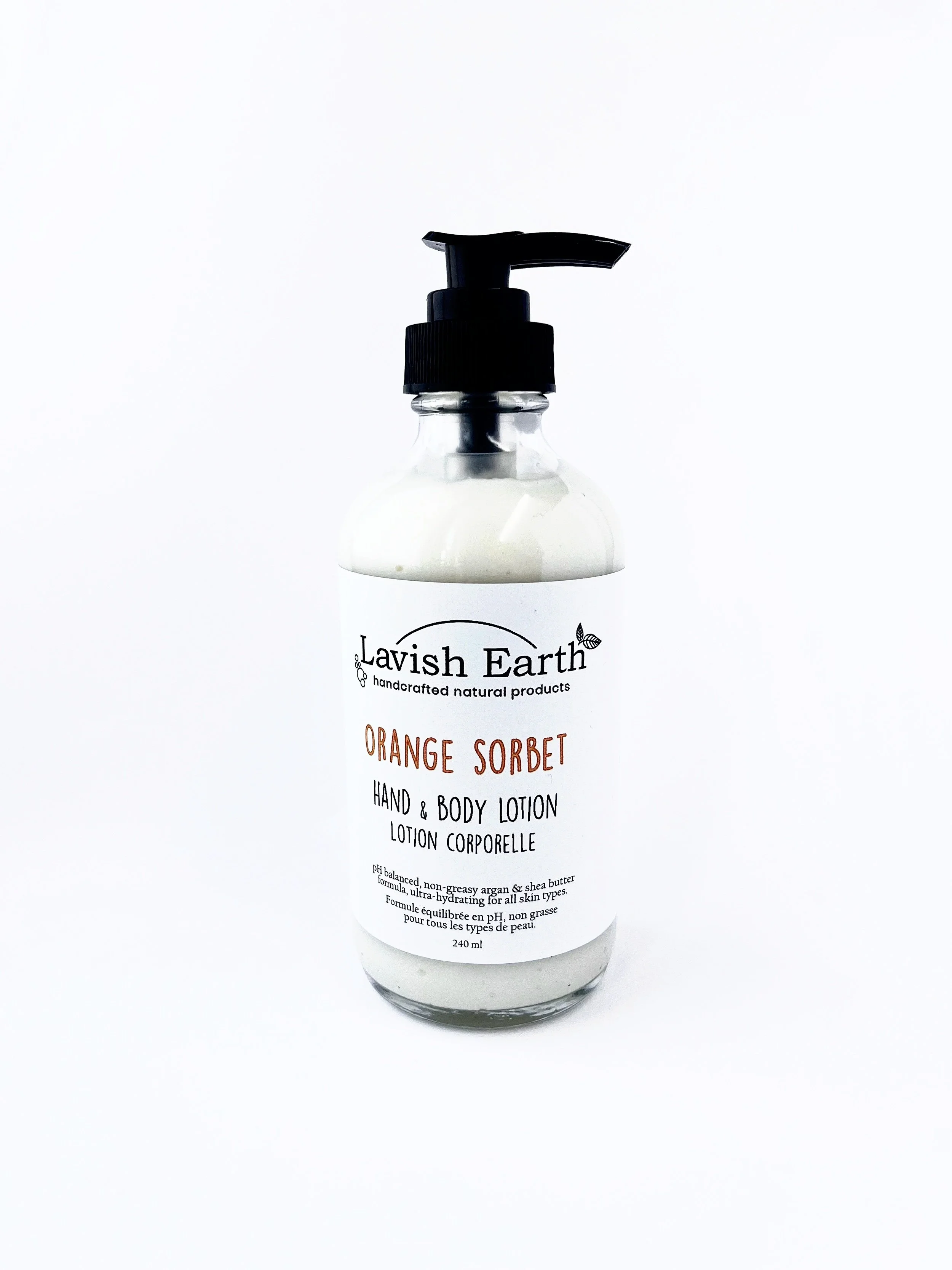 Lavish Earth orange sorbet hand and body lotion in glass bottle with pump, small batch, handcrafted in Grand Valley Ontario