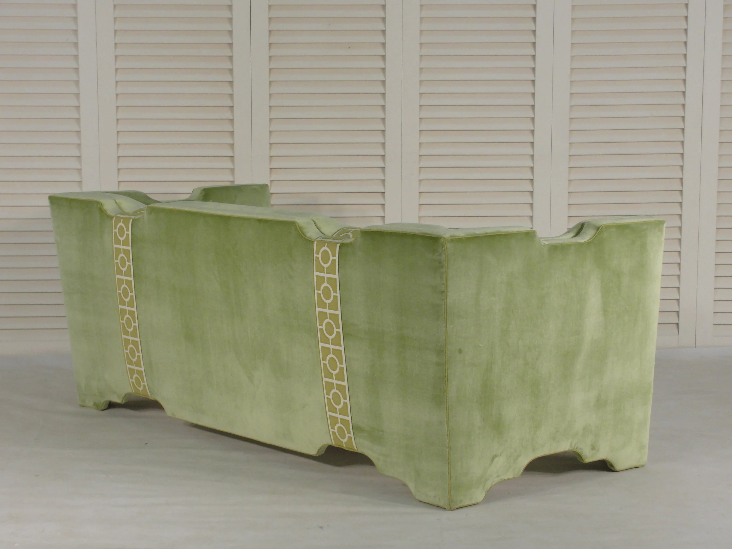 Green sofa with tape trim detail
