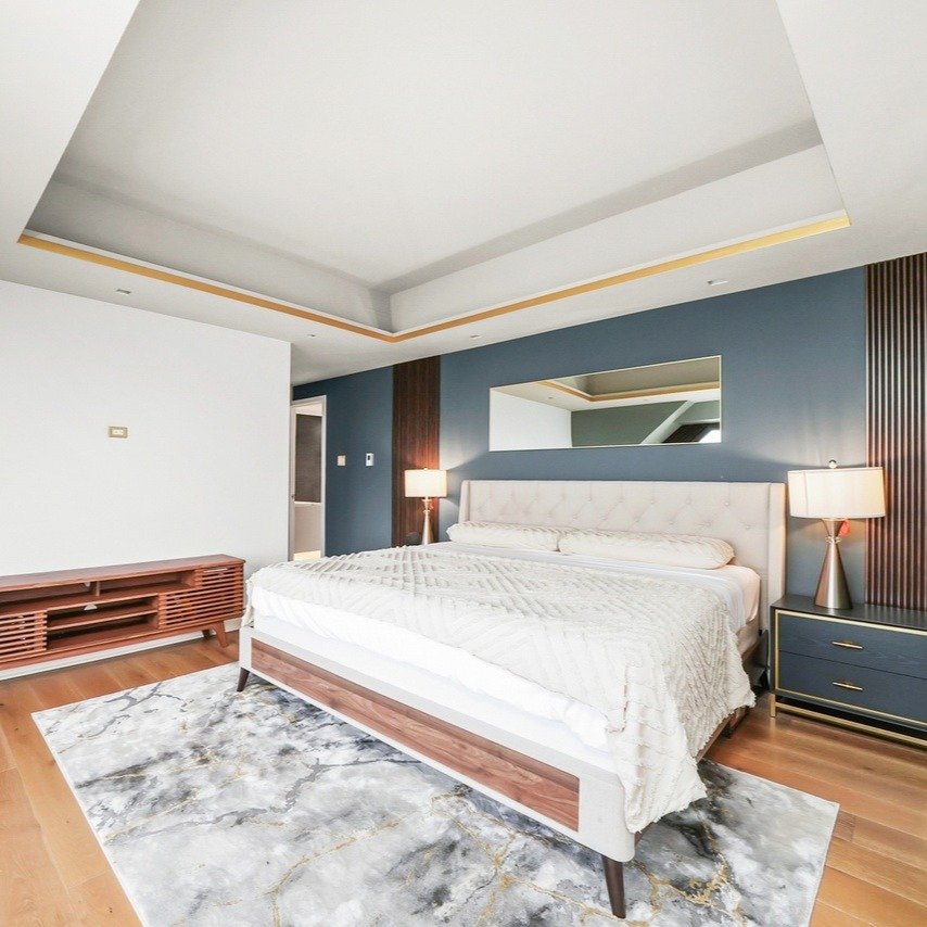 Crisp textures, calming tones, and an unbeatable view from bed&mdash;this John Hancock Center bedroom and bathroom is city serenity at its finest. #PavlovcikArchitecture #ModernRemodel #JohnHancockCenter #Architecture #Architect #Instagram #Insta