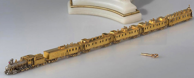 The miniature locomotive and its golden carriages