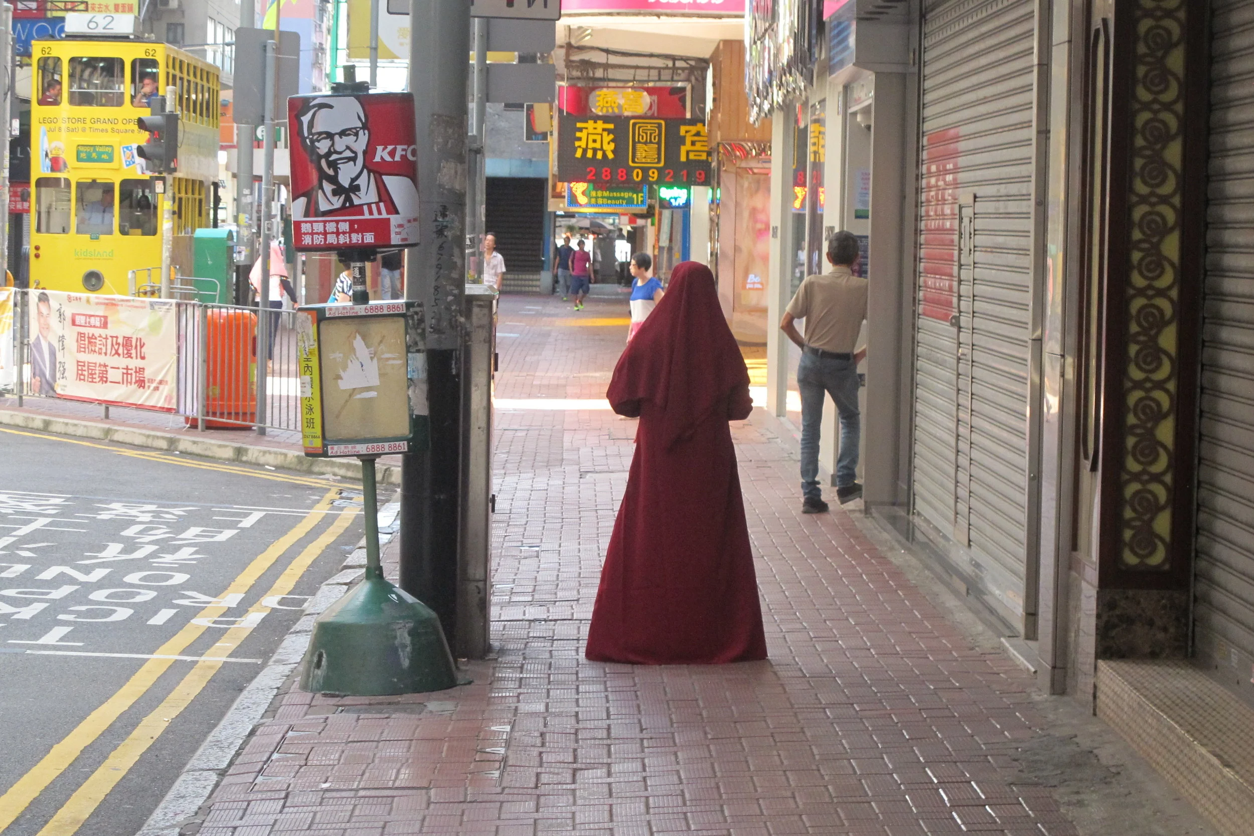 Original trams, KFC and a young girl on the streets of Causeway Bay, Hong Kong