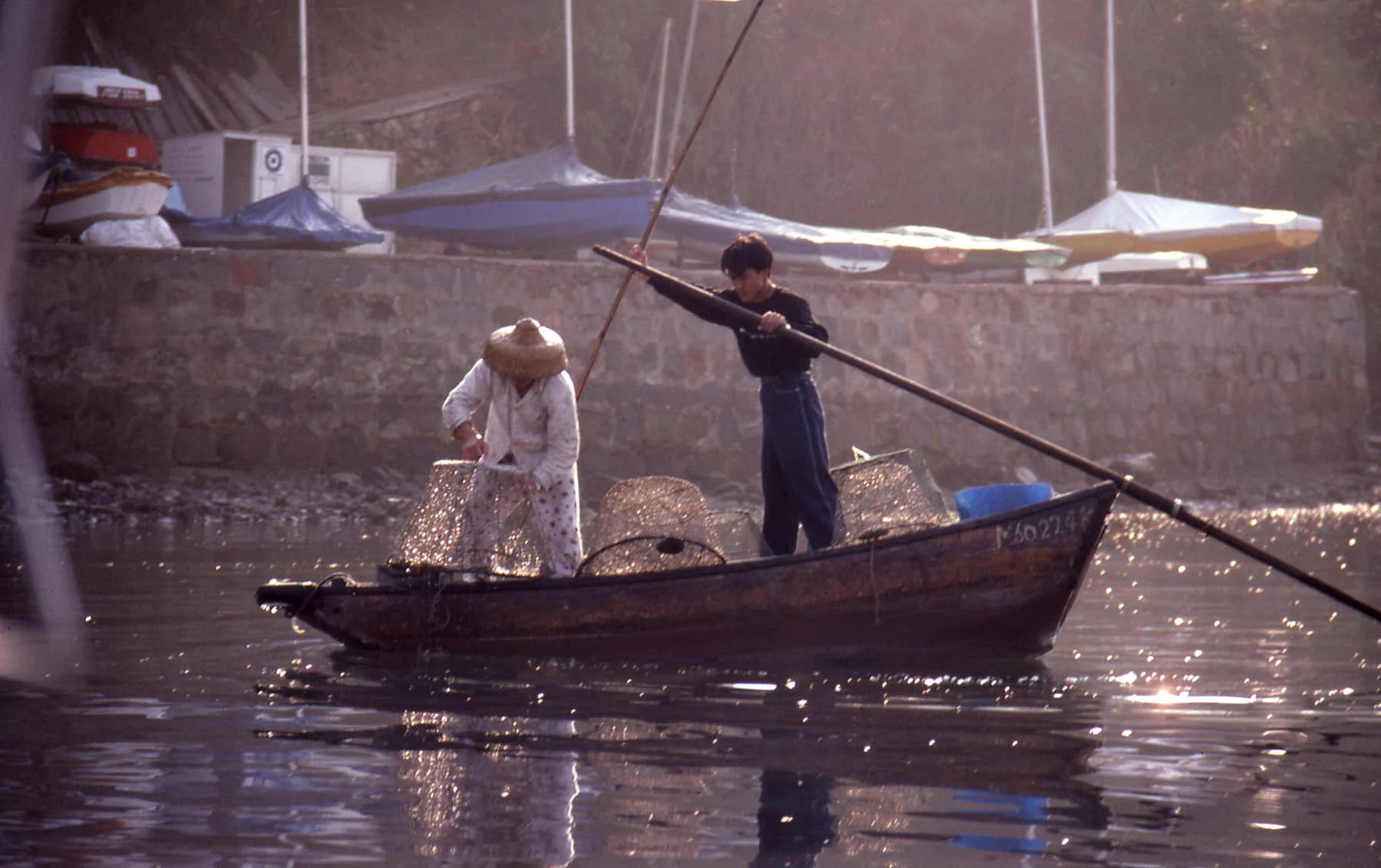 I particularly love the way Greta has captured the shimmer of sunlight turning the fishing baskets to gold mesh. The Enterprise sailing dinghies in the background indicate how we did not have to go out looking for such magnificent shots., they were everyday life. Copyright Greta Solly 1969