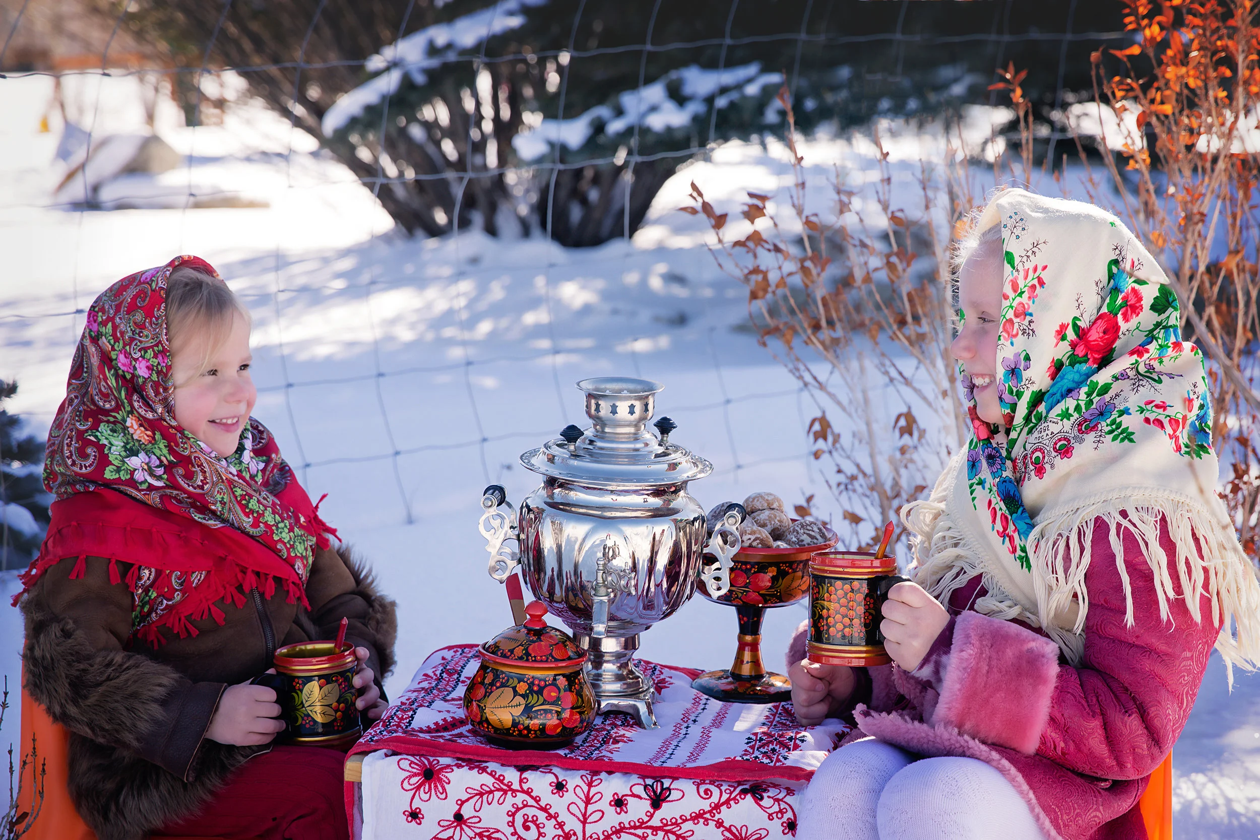 Russian inspired photoshoot. Two sisters are dressed in Russian traditional clothes and drinking tea from Russian traditional dishes and Samovar. Russian Canadian Photographer - Milashka Photography