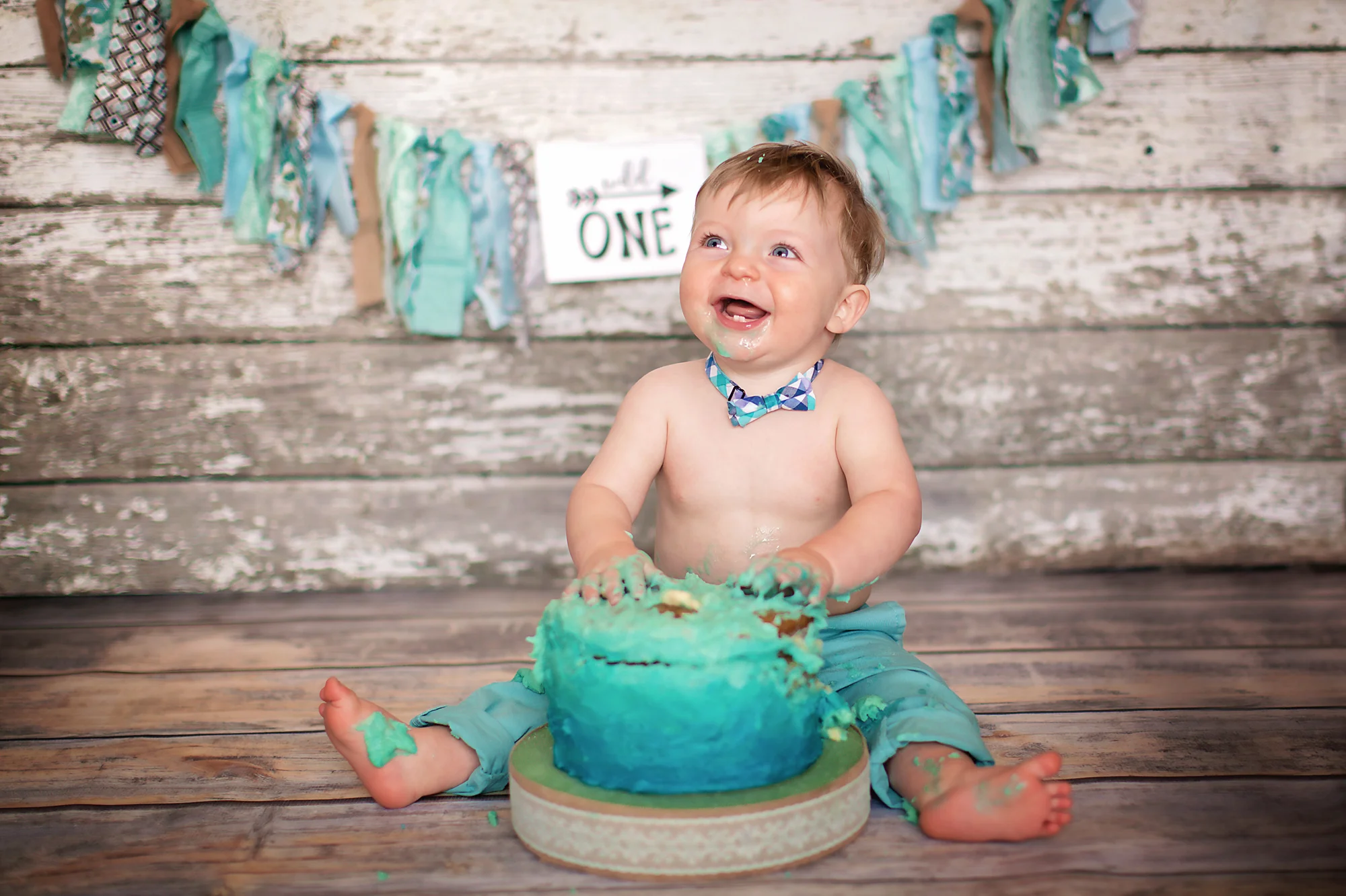 Birthday boy is very happy smashing his cake. Airdrie Cakesmash Photographer - Milashka Photography