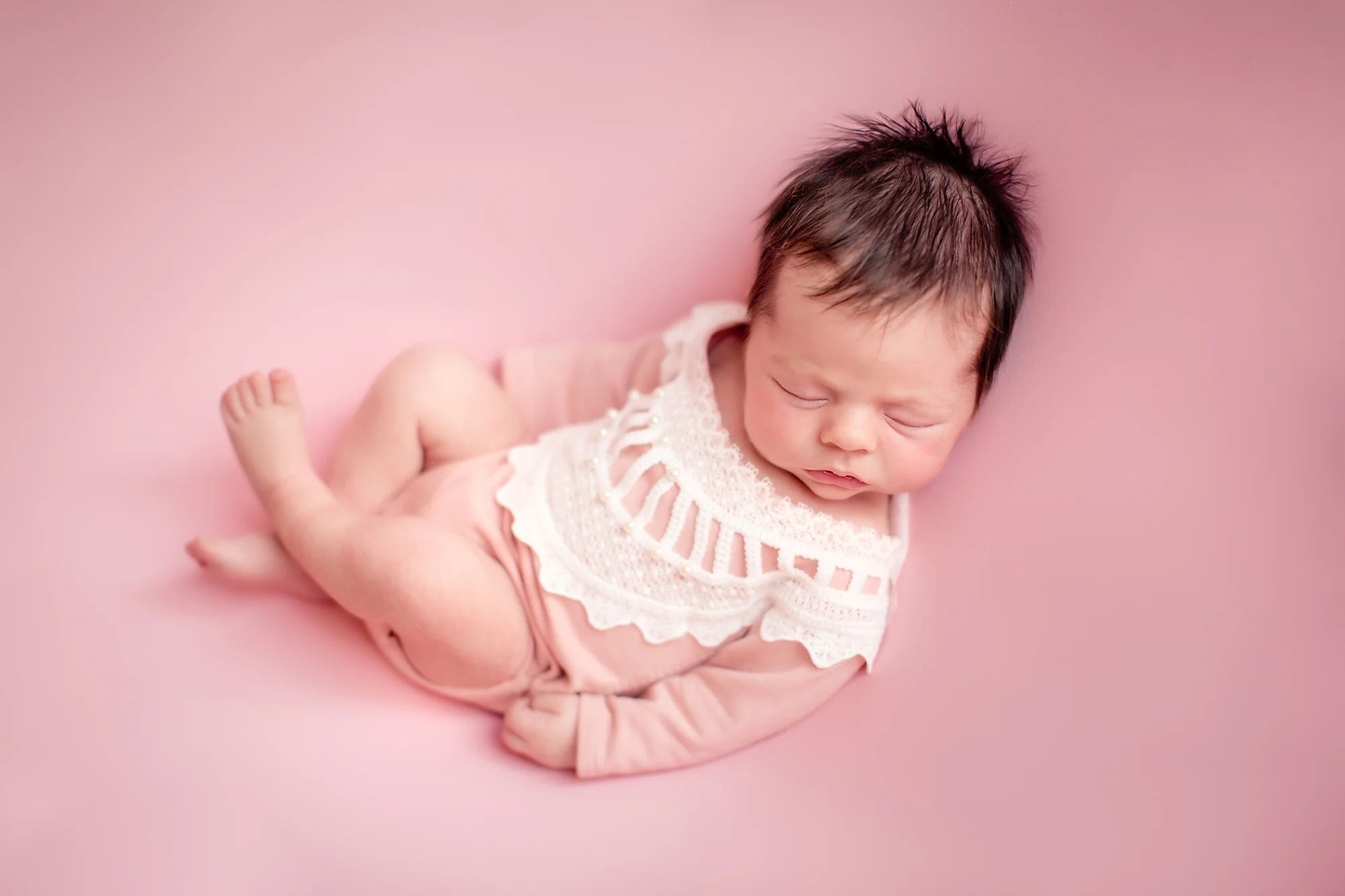 Newborn baby girl photoshoot idea. Calgary and Airdrie Newborn Photographer - Milashka Photography. Huck Finn pose. Baby girl on a beanbag.