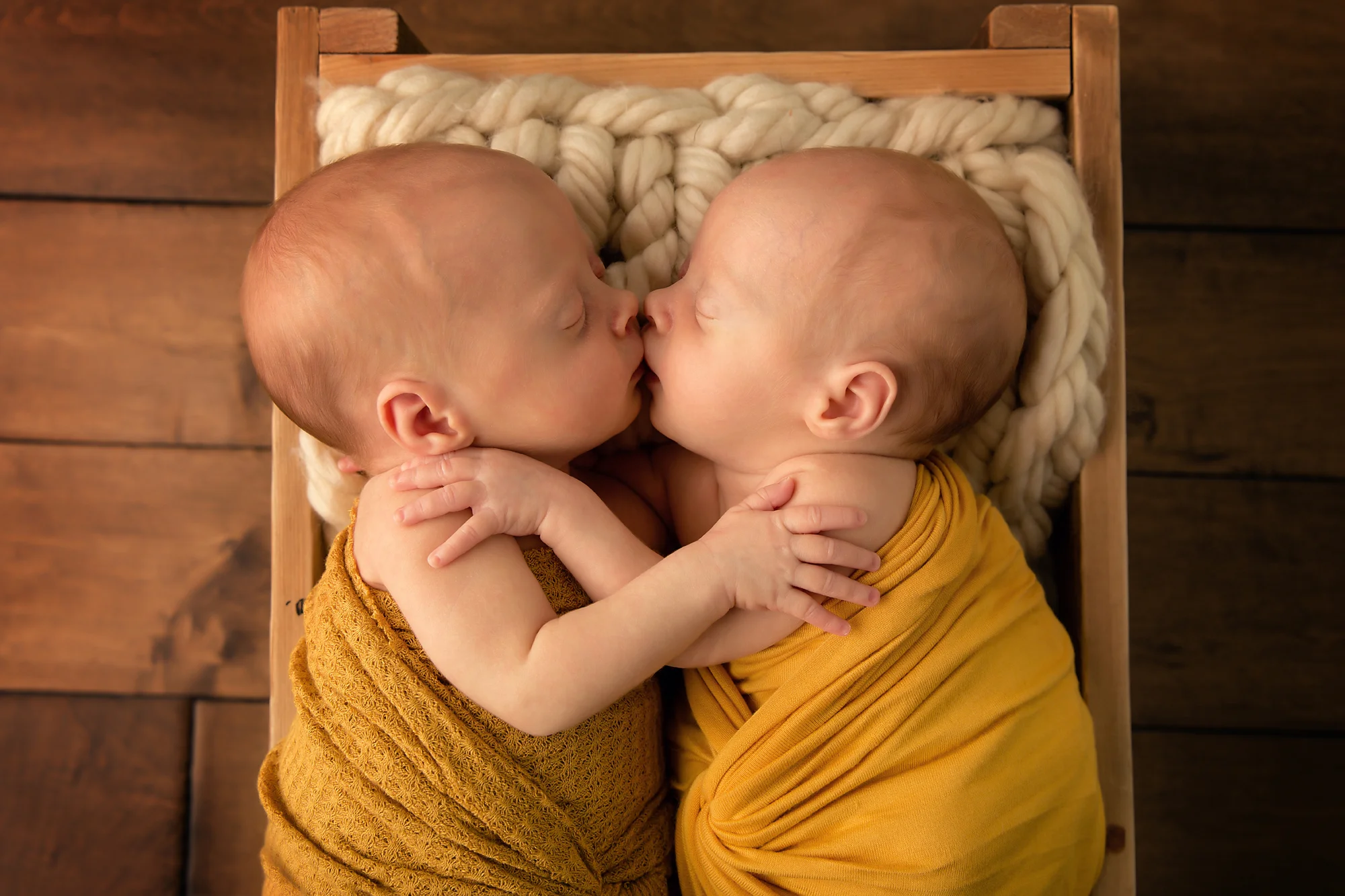 Twins Photography in Calgary, Alberta by Milashka Photography. Twin sisters are giving each other a kiss and a hug