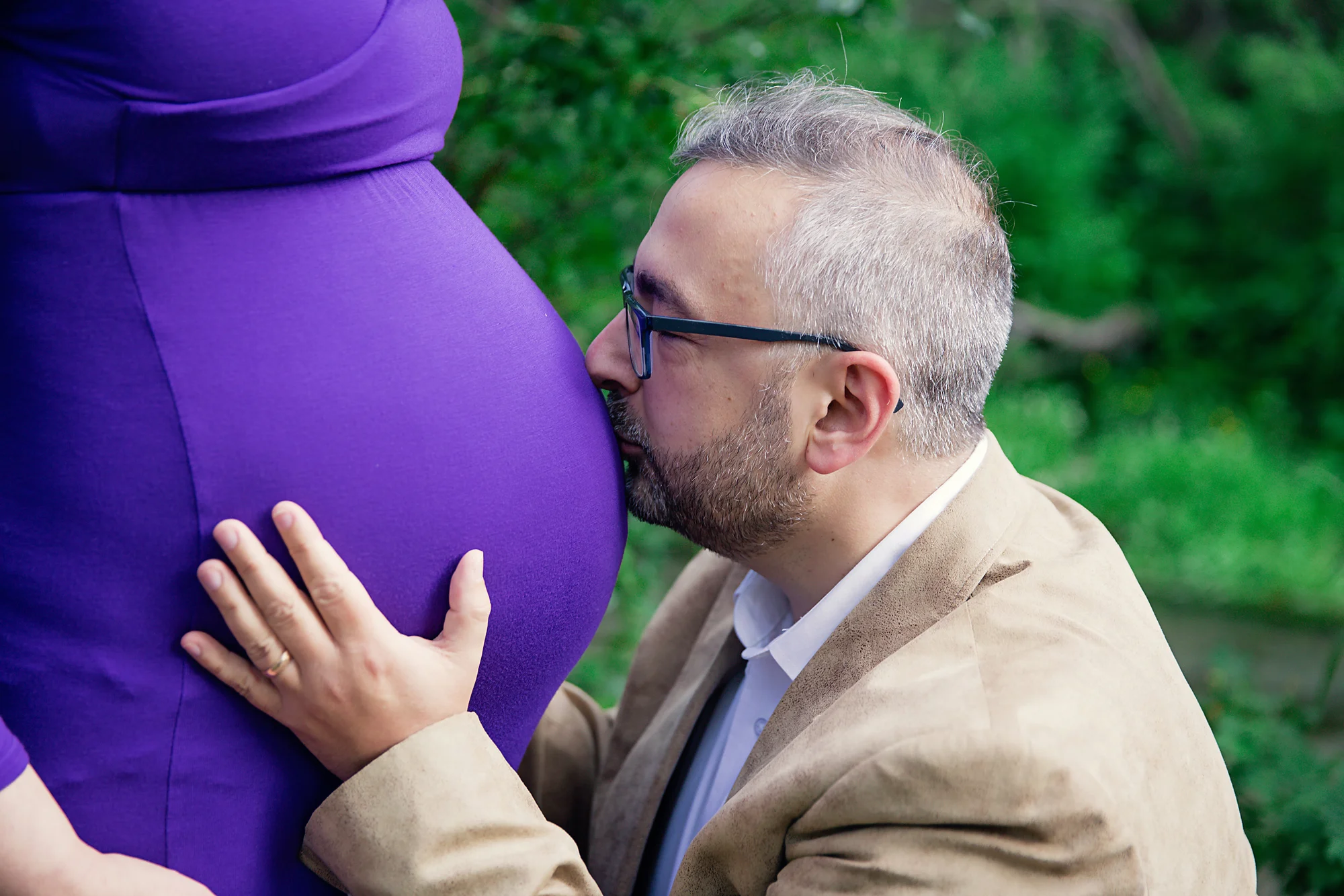 Father-to-be is kissing the belly. Maternity inspirational photos. Calgary and Airdrie Maternity photographer