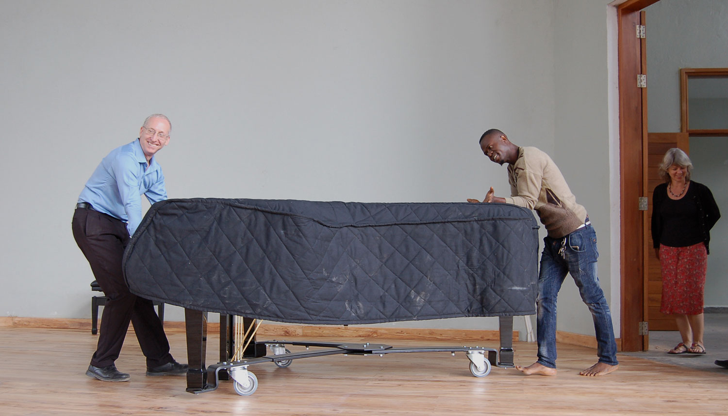  Randy Stubbs, CAC Programme Manager, and Abbas Haji, CAC Artist, move the piano onto the CAC performance stage for rehearsals in preparation of the chamber music concert. 