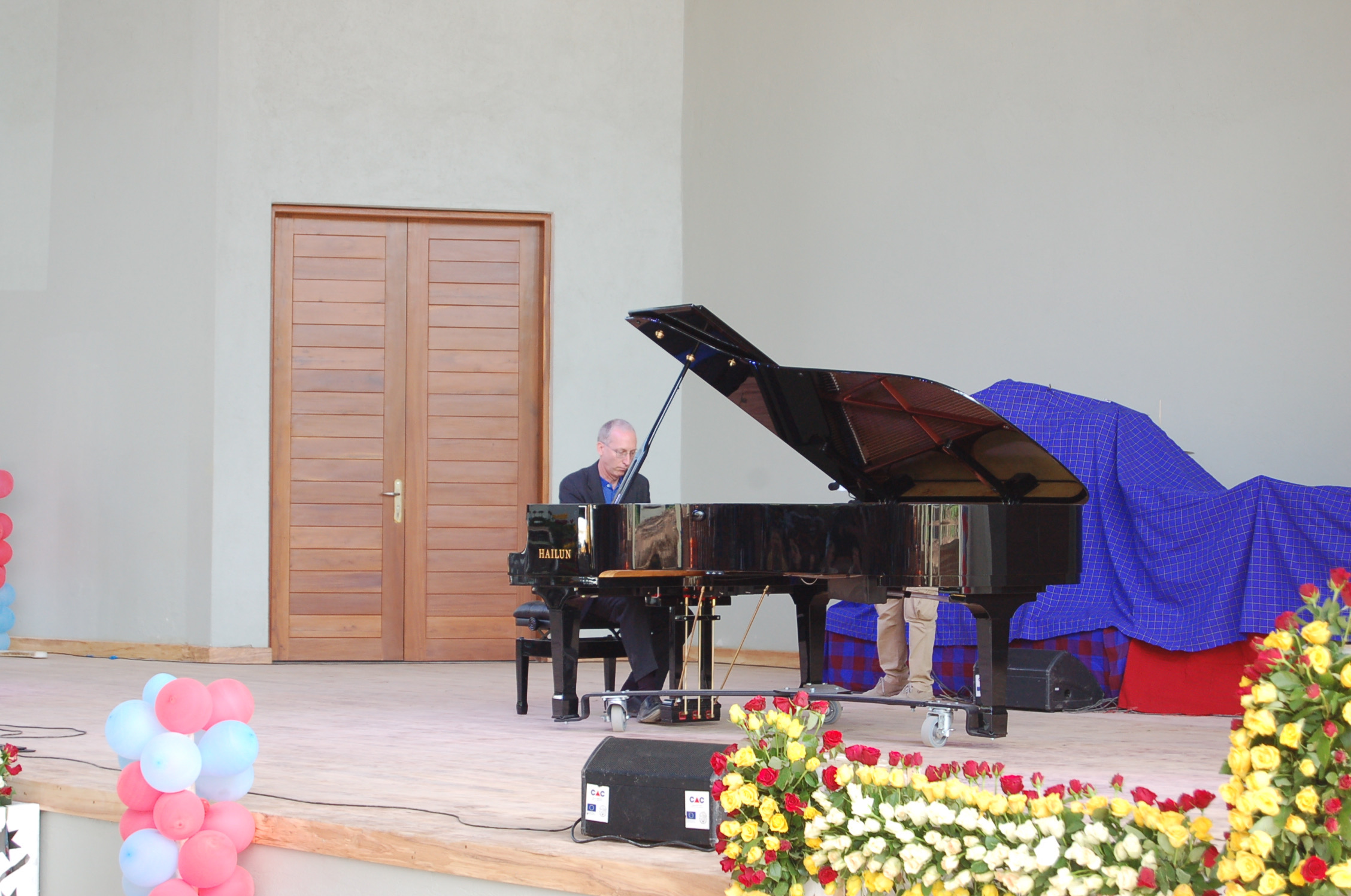  Randy Stubbs, CAC Programme Manager, plays the concert grand piano during the CAC Dedication Ceremony. This grand piano was generously donated by friends in the United States of America under coordination of Dr. Abe Caceres of World House Music, Nor