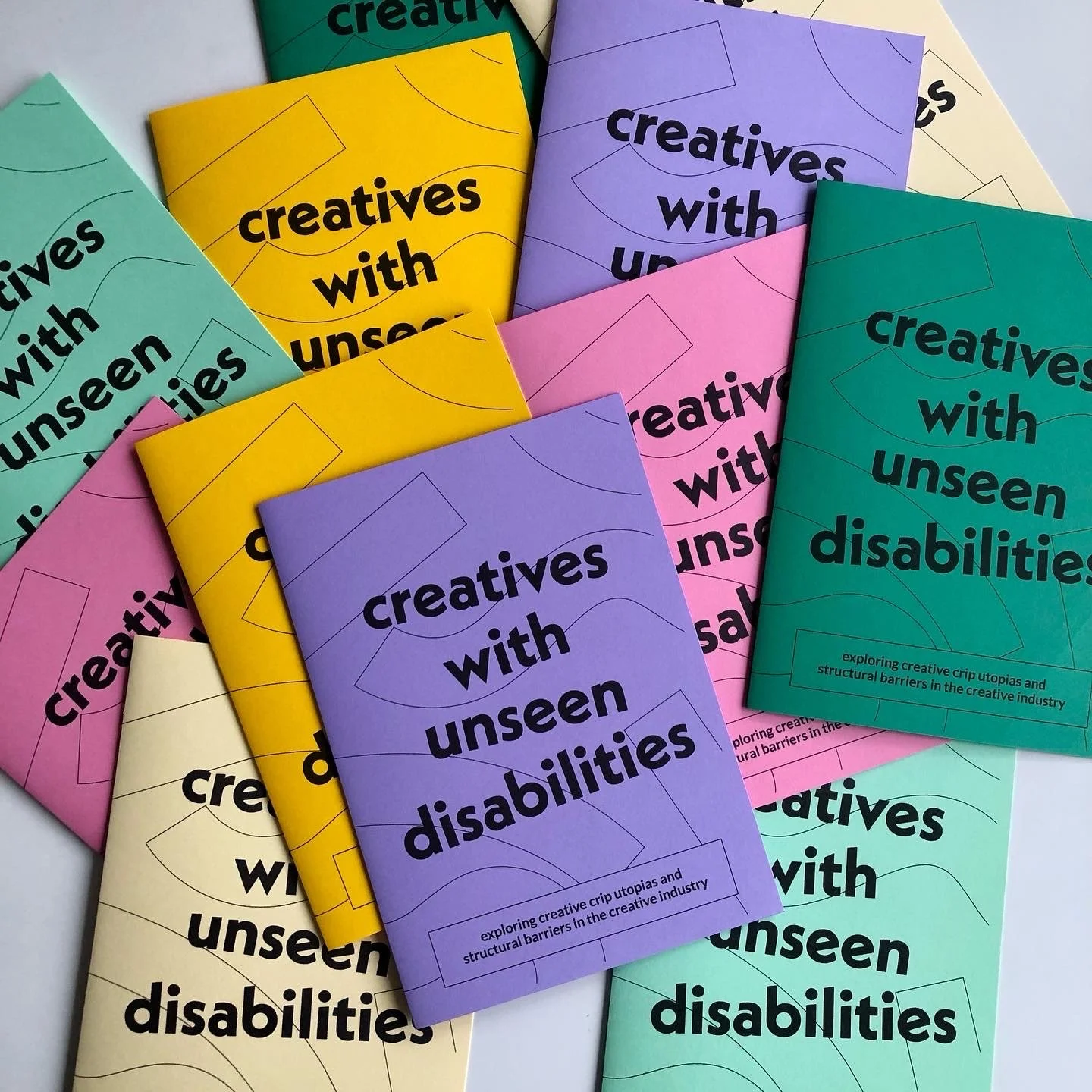 Creatives with Unseen Disabilities zines displayed on a table