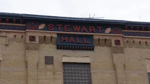  Front of a brick building with a “Stewart Hall” sign above the entrance.