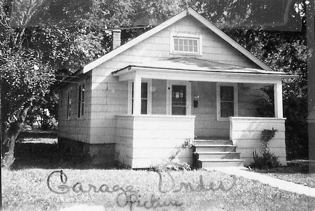 Black-and-white photo of a small one-story bungalow with a front porch and steps; handwritten caption along the bottom.