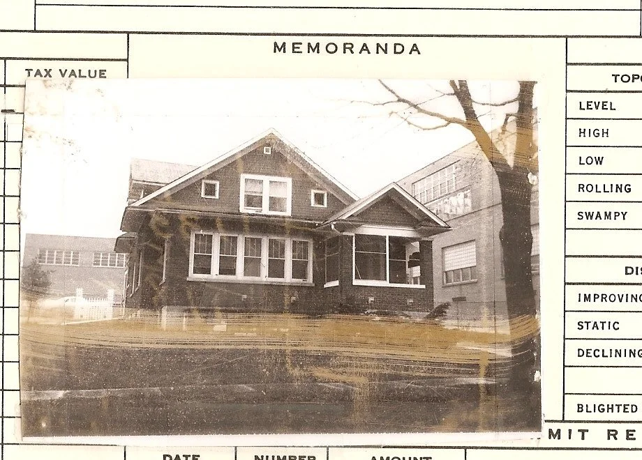 Black-and-white photo of a single-story Craftsman bungalow pasted onto a memorandum form showing columns labeled “Tax Value” and topography categories.