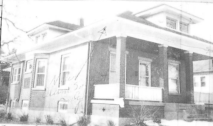 Front and side view of a brick bungalow house with covered porch and snow.