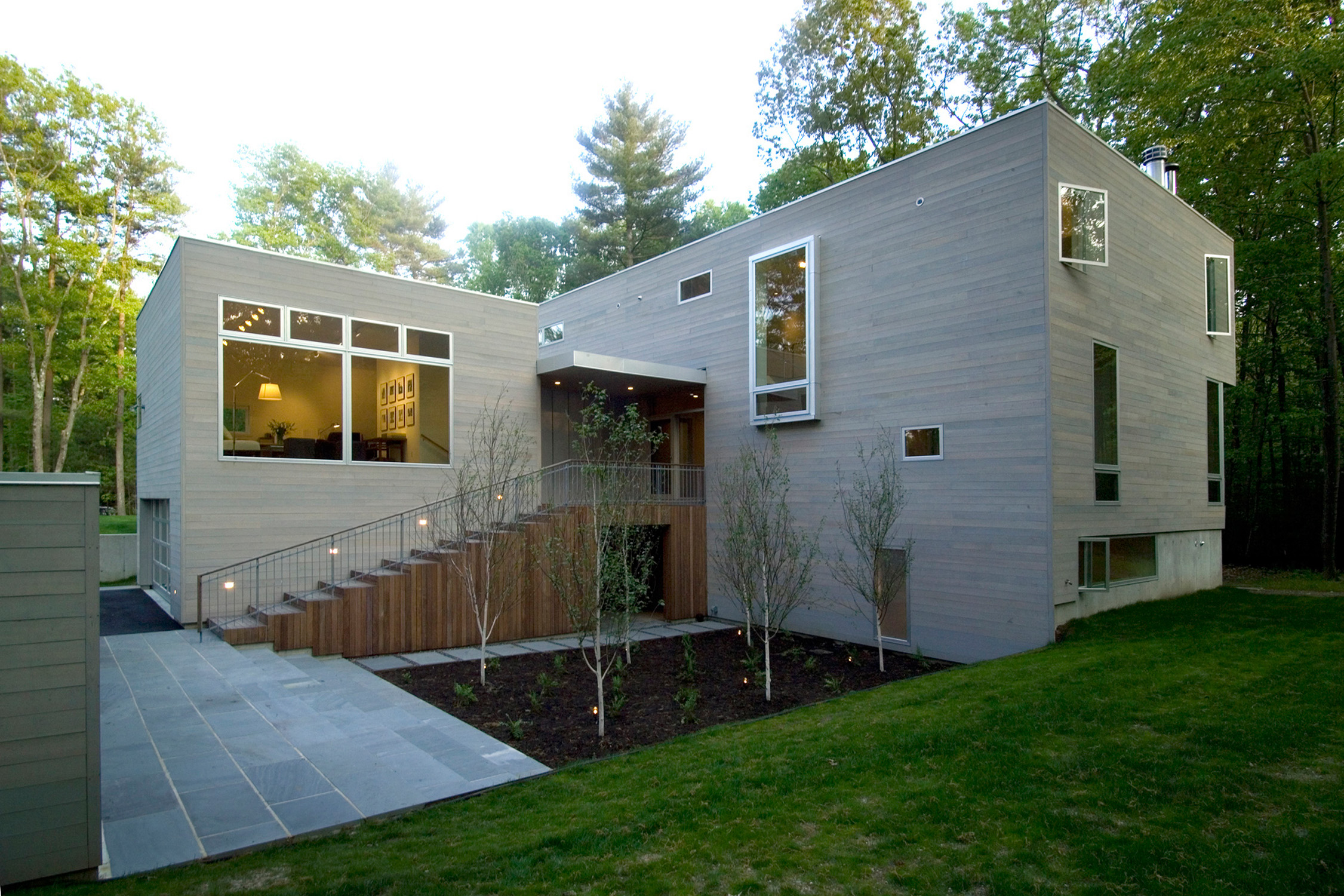 The design solution places 2 highly crafted boxes in the woods whose entry sequence orchestrates a dramatic threshold welcoming people into the forest. These volumes are then given 3 primary orientations for the different activities engaged by this active household: ...