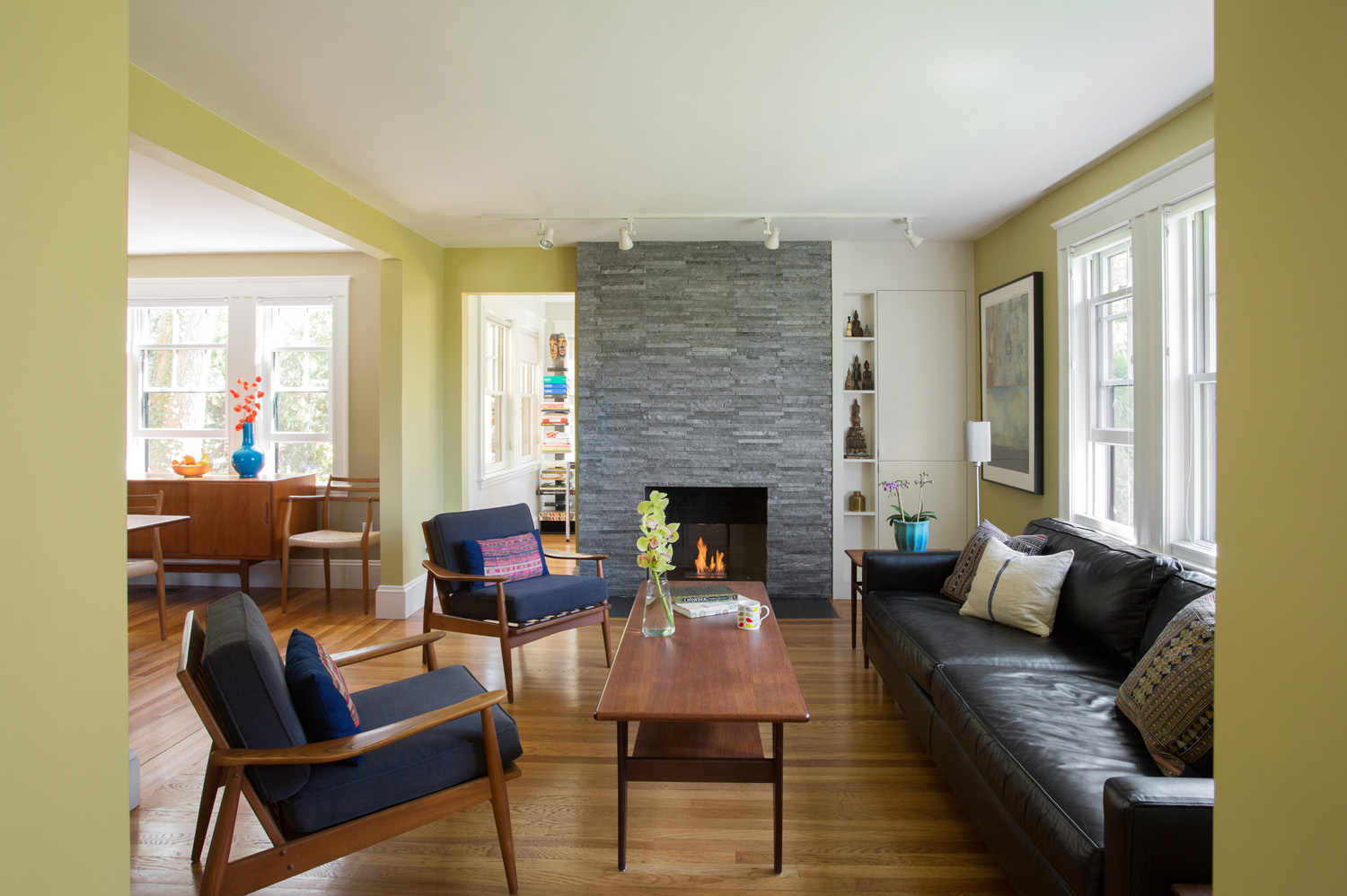 The dark old brick chimney was re-faced with modern tile, and new built-in cabinets were constructed for the client's collection of Buddahs.