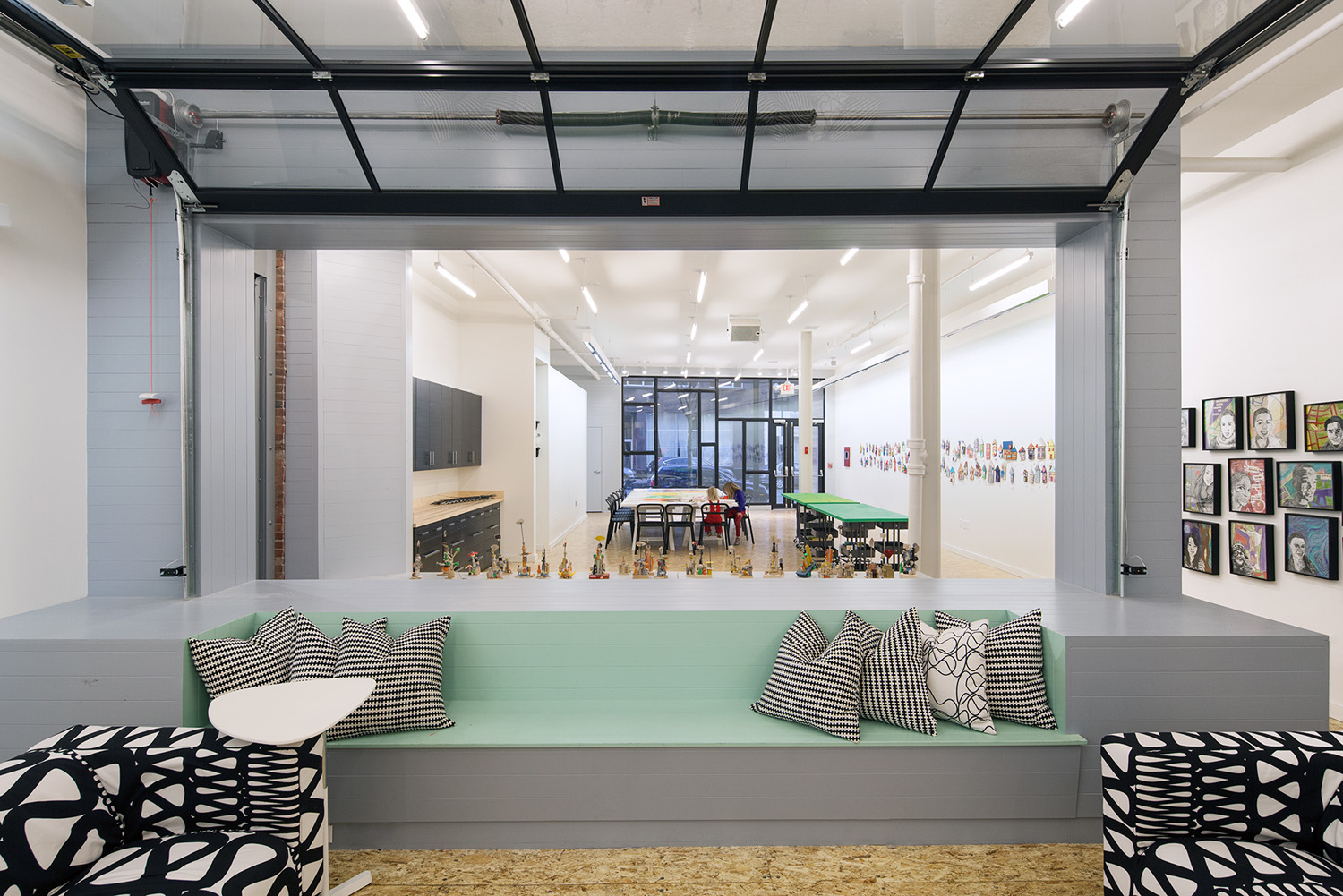 Large glass garage doors provide remarkable flexibility, allowing the three programmatic spaces to be divided from each other (to improve acoustics) or connected to each other (for events and larger activities).