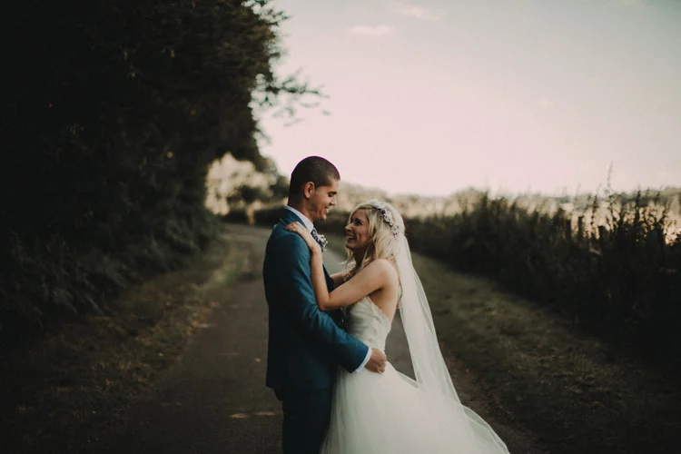 boho bride and groom hold each other in intimate moment in chesham wedding