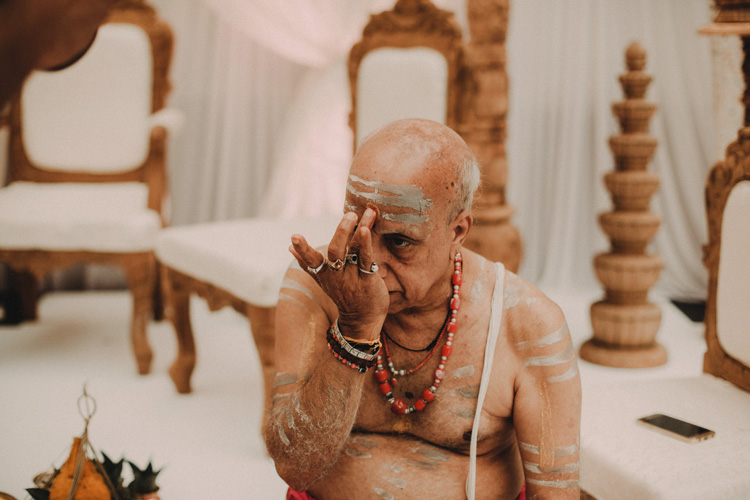 priest prepares himself for hindu ceremony