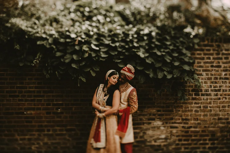 indian bride and groom share intimate moment in london hindu wedding